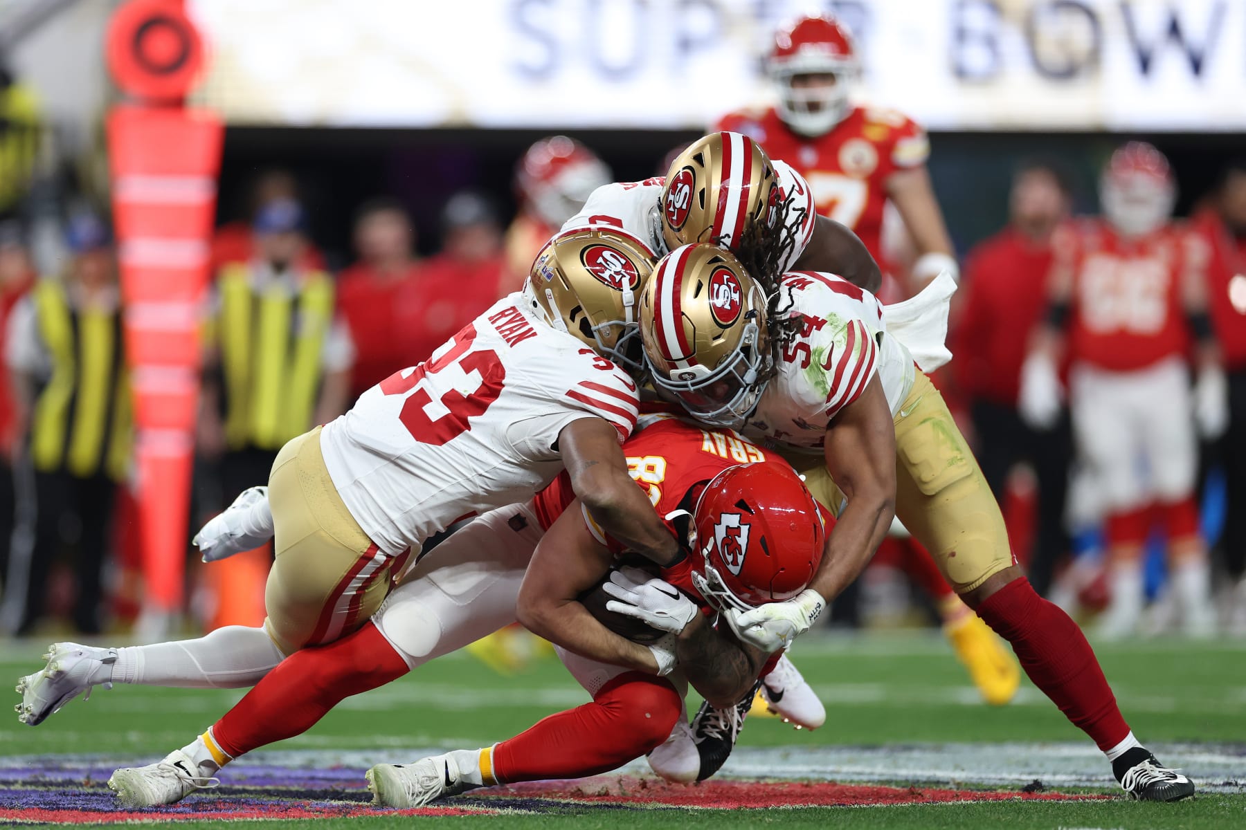 LAS VEGAS, NEVADA - FEBRUARY 11: Logan Ryan #33 and Fred Warner #54 of the San Francisco 49ers tackle Noah Gray #83 of the Kansas City Chiefs in the third quarter during Super Bowl LVIII at Allegiant Stadium on February 11, 2024 in Las Vegas, Nevada. (Photo by Ezra Shaw/Getty Images)