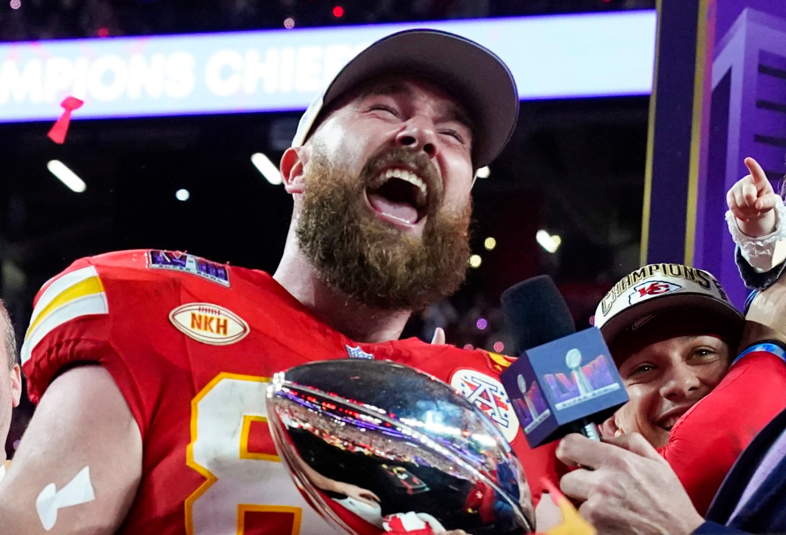 Kansas City Chiefs' tight end #87 Travis Kelce holds the trophy next to Kansas City Chiefs' quarterback #15 Patrick Mahomes as they celebrate winning Super Bowl LVIII against the San Francisco 49ers at Allegiant Stadium in Las Vegas, Nevada, February 11, 2024. (Photo by TIMOTHY A. CLARY / AFP) (Photo by TIMOTHY A. CLARY/AFP via Getty Images)