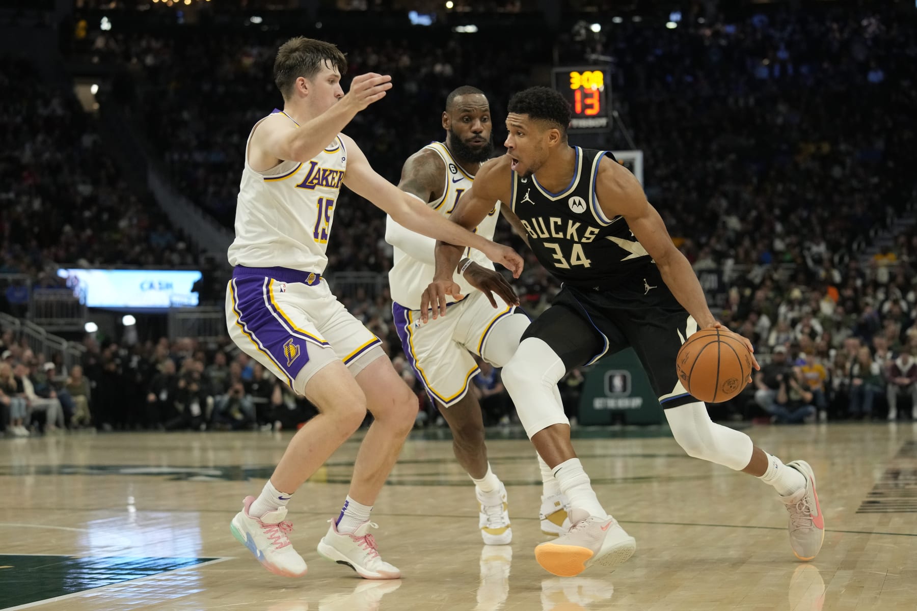 MILWAUKEE, WISCONSIN - DECEMBER 02: Giannis Antetokounmpo #34 of the Milwaukee Bucks dribbles the ball against Austin Reaves #15 and LeBron James #6 of the Los Angeles Lakers during the second half at Fiserv Forum on December 02, 2022 in Milwaukee, Wisconsin. NOTE TO USER: User expressly acknowledges and agrees that, by downloading and or using this photograph, User is consenting to the terms and conditions of the Getty Images License Agreement. (Photo by Patrick McDermott/Getty Images)