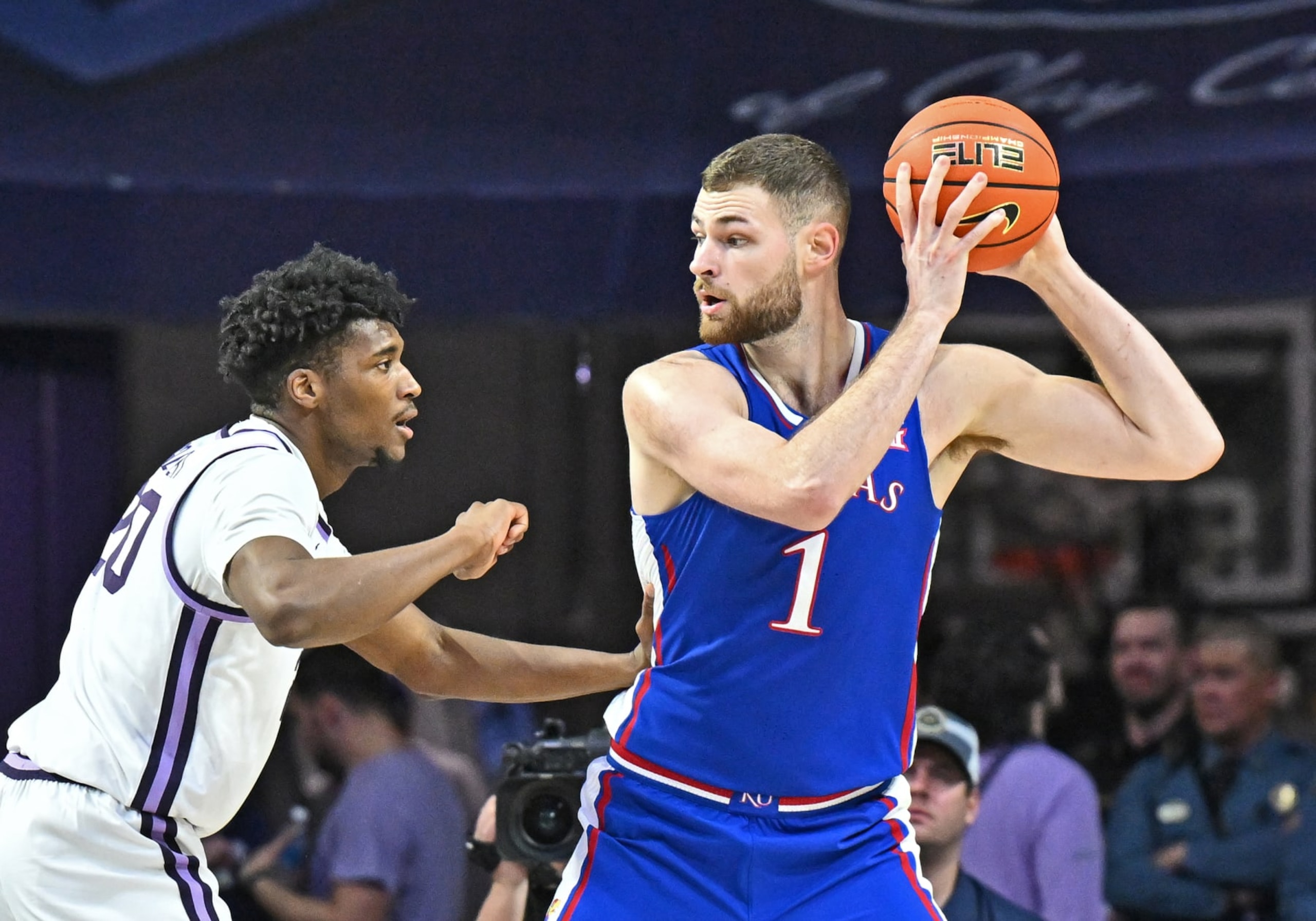 MANHATTAN, KS - FEBRUARY 05:  Hunter Dickinson #1 of the Kansas Jayhawks with the ball against Jerrell Colbert #20 of the Kansas State Wildcats in the second half at Bramlage Coliseum on February 05, 2024 in Manhattan, Kansas.  (Photo by Peter G. Aiken/Getty Images)