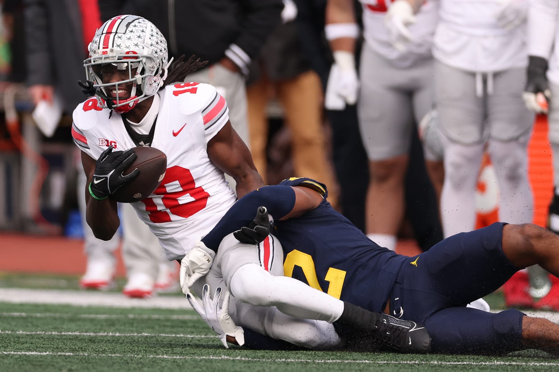 ANN ARBOR, MICHIGAN - NOVEMBER 25: Marvin Harrison Jr. #18 of the Ohio State Buckeyes makes a one handed catch next to Will Johnson #2 of the Michigan Wolverines at Michigan Stadium on November 25, 2023 in Ann Arbor, Michigan. (Photo by Gregory Shamus/Getty Images)