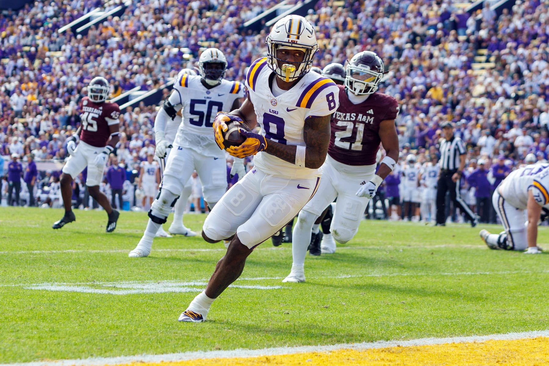 BATON ROUGE, LA - NOVEMBER 25: LSU Tigers wide receiver Malik Nabers (8) scores a touchdown during a game between the Texas A&M Aggies and the LSU Tigers on November 25, 2023, at Tiger Stadium in Baton Rouge, Louisiana. (Photo by John Korduner/Icon Sportswire via Getty Images)
