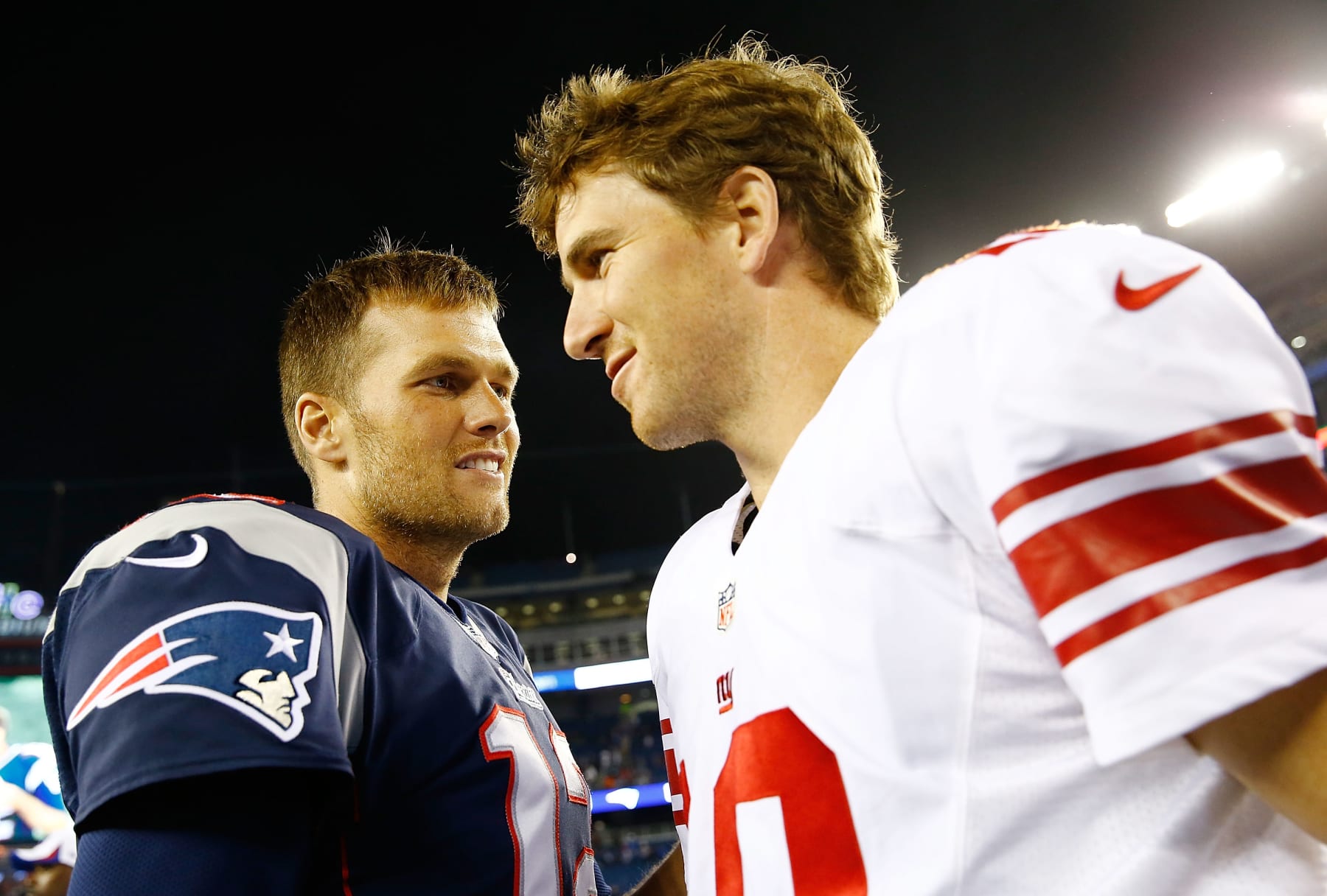 FOXBORO, MA - AUGUST 29: Tom Brady #12 of the New England Patriots talks to Eli Manning #10 of the New York Giants following their preseason game at Gillette Stadium on August 29, 2013 in Foxboro, Massachusetts. (Photo by Jared Wickerham/Getty Images)