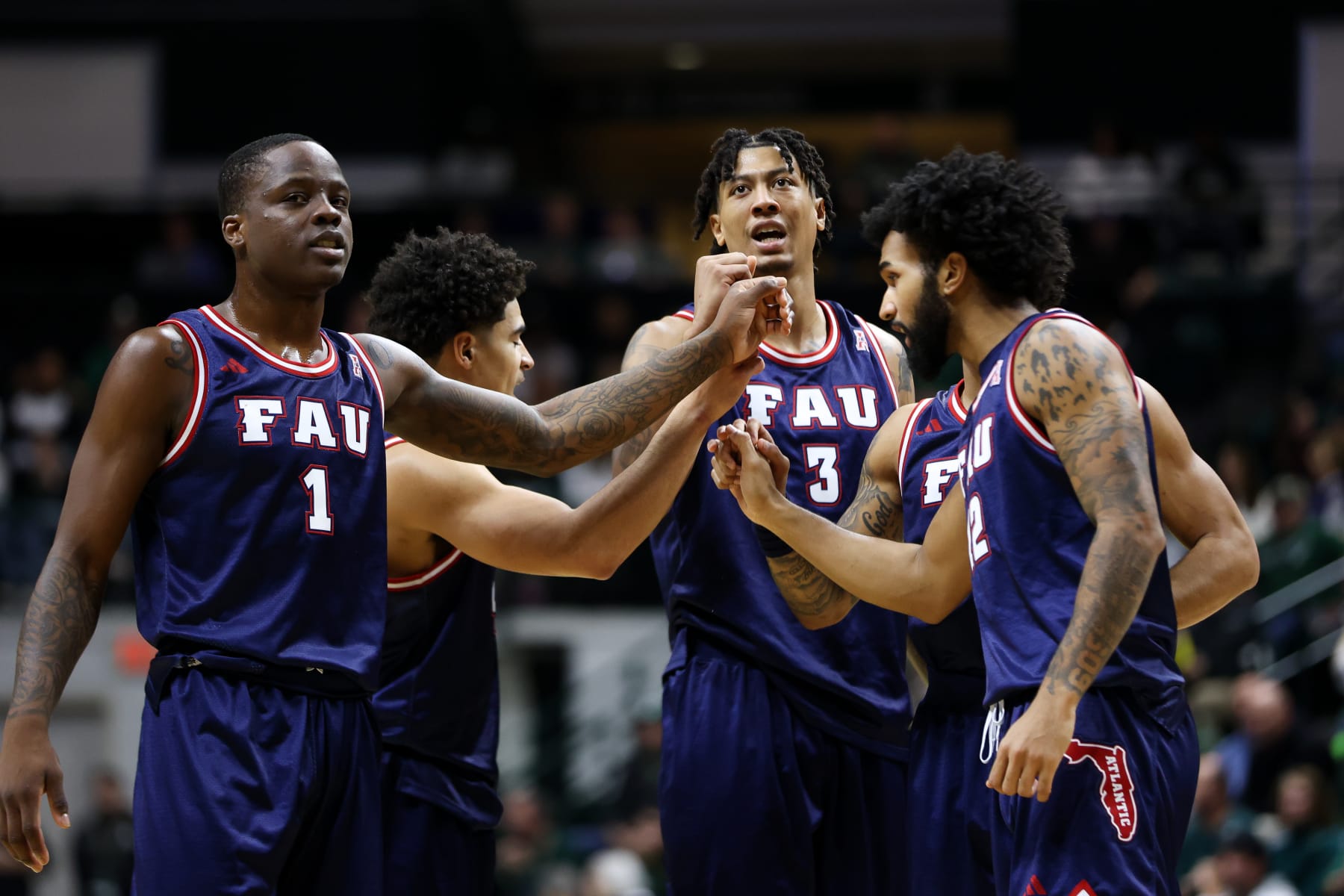 CHARLOTTE, NORTH CAROLINA - JANUARY 6: Giancarlo Rosado #3 of the Florida Atlantic Owls and Johnell Davis #1 of the Florida Atlantic Owls huddle during the second half against the Charlotte 49ers at Dale F. Halton Arena on January 6, 2024 in Charlotte, North Carolina. (Photo by Isaiah Vazquez/Getty Images)
