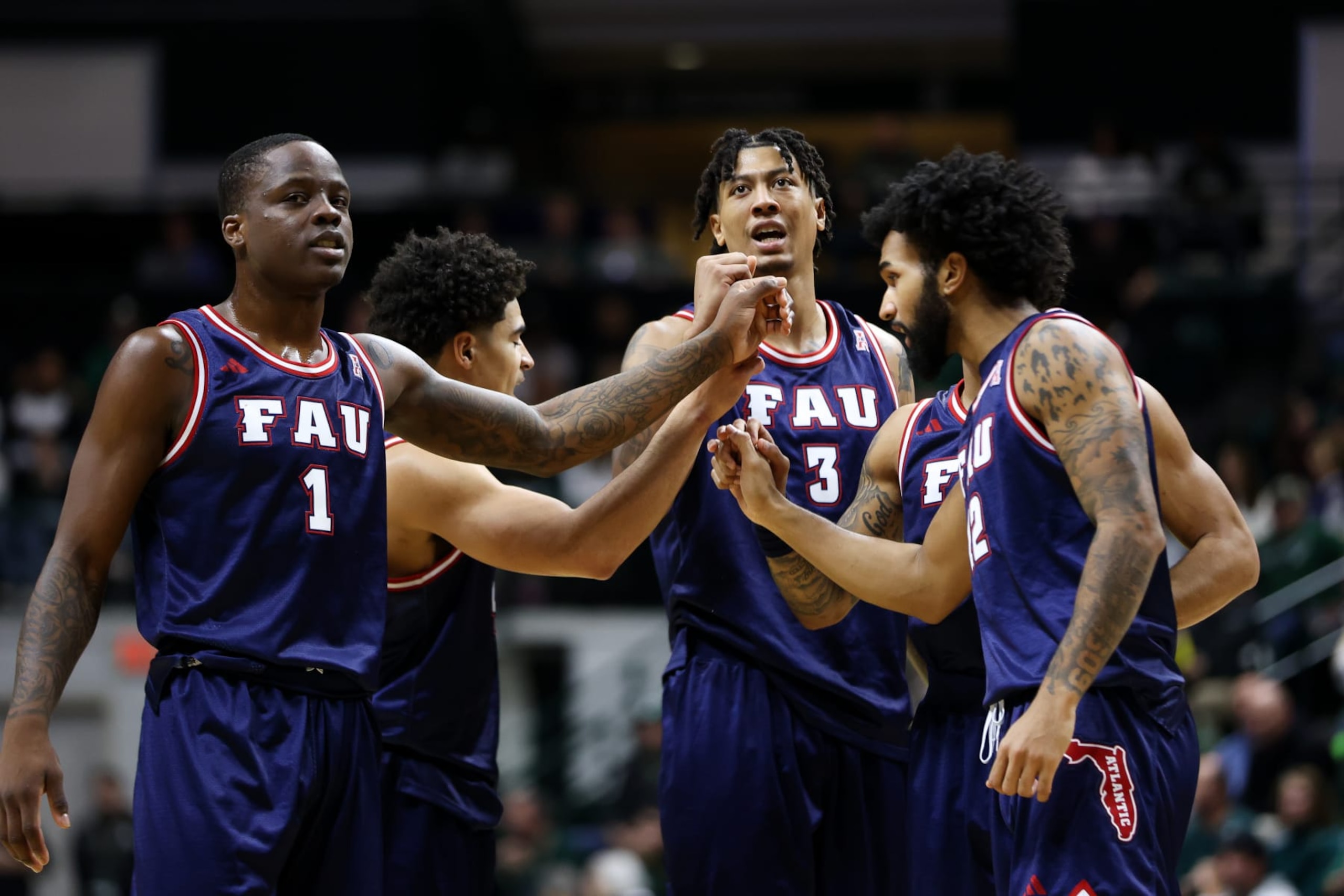 CHARLOTTE, NORTH CAROLINA - JANUARY 6: Giancarlo Rosado #3 of the Florida Atlantic Owls and Johnell Davis #1 of the Florida Atlantic Owls huddle during the second half against the Charlotte 49ers at Dale F. Halton Arena on January 6, 2024 in Charlotte, North Carolina. (Photo by Isaiah Vazquez/Getty Images)