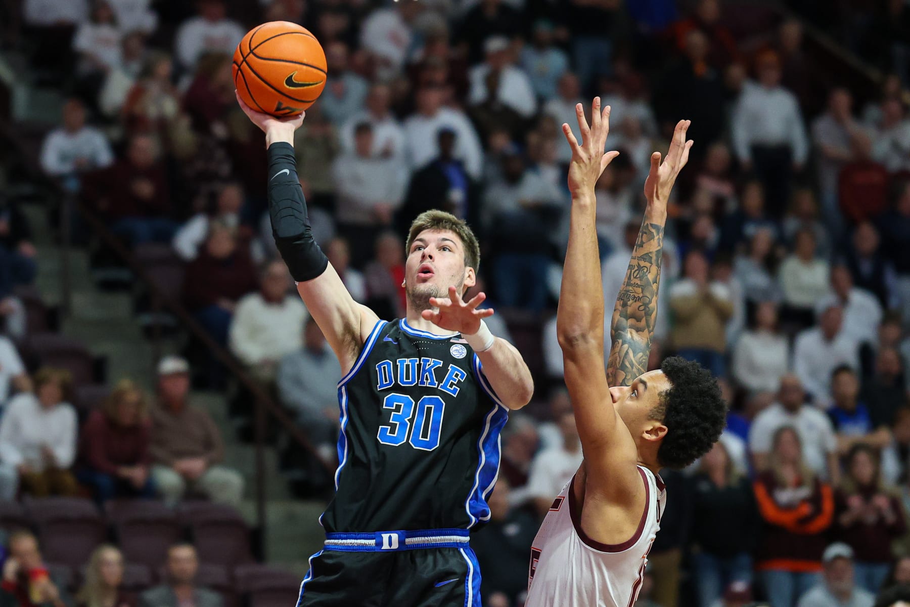 BLACKSBURG, VIRGINIA - JANUARY 29: Kyle Filipowski #30 of the Duke Blue Devils shoots over Lynn Kidd #15 of the Virginia Tech Hokies in the first half during a game at Cassell Coliseum on January 29, 2024 in Blacksburg, Virginia. (Photo by Ryan Hunt/Getty Images)