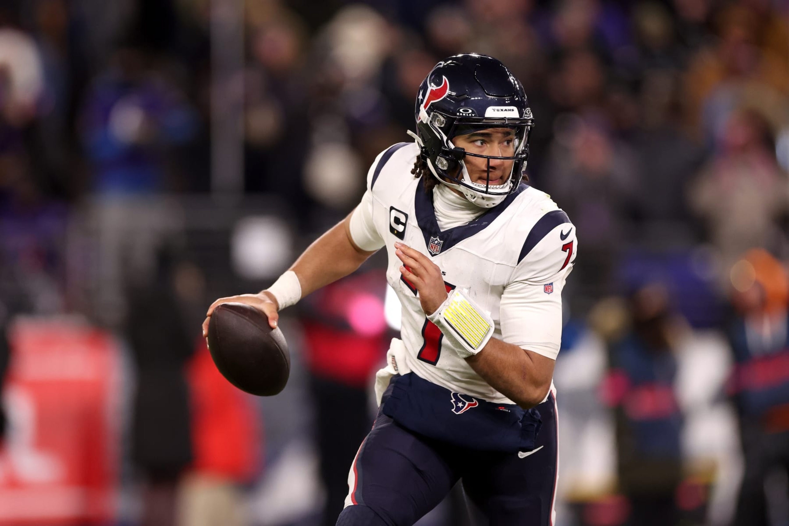 BALTIMORE, MARYLAND - JANUARY 20: Quarterback C.J. Stroud #7 of the Houston Texans rolls out to pass against the Baltimore Ravens in the second half at M&T Bank Stadium on January 20, 2024 in Baltimore, Maryland. (Photo by Rob Carr/Getty Images)