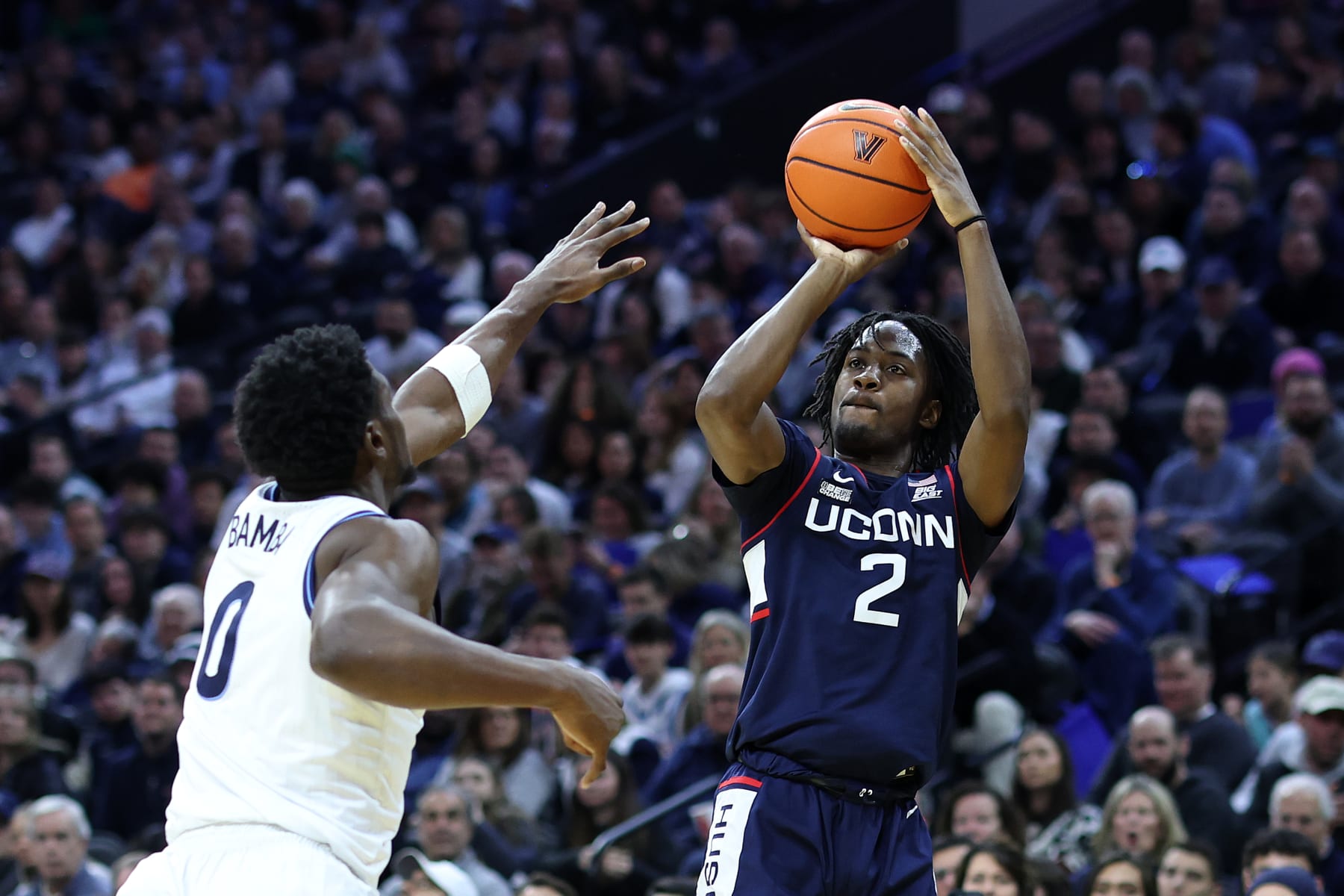 PHILADELPHIA, PENNSYLVANIA - JANUARY 20: Tristen Newton #2 of the Connecticut Huskies shoots over TJ Bamba #0 of the Villanova Wildcats during the first half at the Wells Fargo Center on January 20, 2024 in Philadelphia, Pennsylvania. (Photo by Tim Nwachukwu/Getty Images)