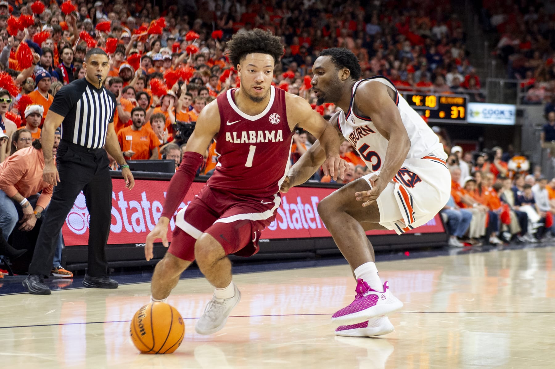 AUBURN, ALABAMA - FEBRUARY 07: Mark Sears #1 of the Alabama Crimson Tide looks to maneuver the ball by Chris Moore #5 of the Auburn Tigers during the first half of play at Neville Arena on February 07, 2024 in Auburn, Alabama. (Photo by Michael Chang/Getty Images)