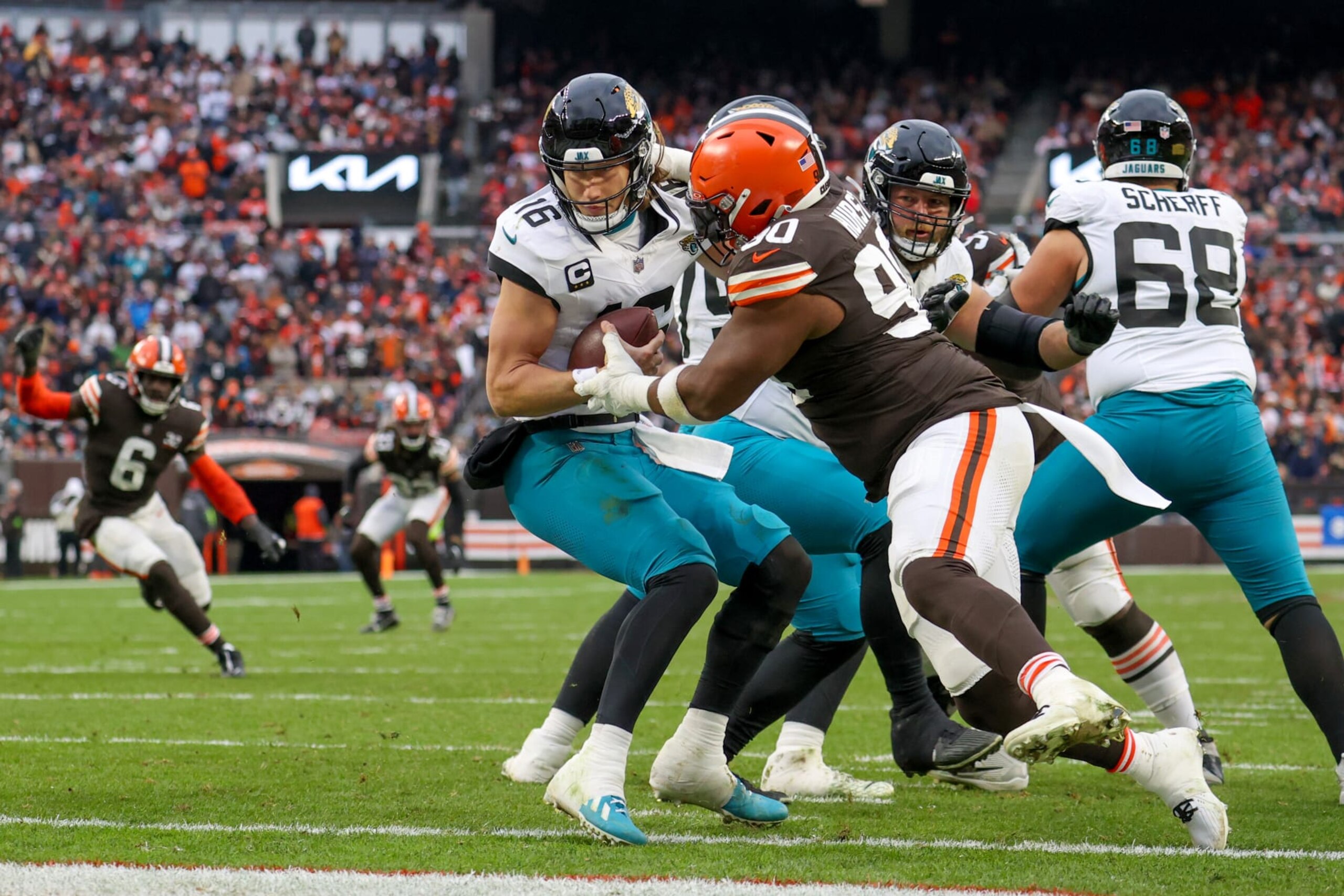 CLEVELAND, OH - DECEMBER 10: Jacksonville Jaguars quarterback Trevor Lawrence (16) eludes the rush of Cleveland Browns defensive tackle Maurice Hurst II (90) during the third quarter of the National Football League game between the Jacksonville Jaguars and Cleveland Browns on December 10, 2023, at Cleveland Browns Stadium in Cleveland, OH. (Photo by Frank Jansky/Icon Sportswire via Getty Images) CLEVELAND, OH - DECEMBER 10: Jacksonville Jaguars quarterback Trevor Lawrence (16) eludes the rush of Cleveland Browns defensive tackle Maurice Hurst II (90) during the third quarter of the National Football League game between the Jacksonville Jaguars and Cleveland Browns on December 10, 2023, at Cleveland Browns Stadium in Cleveland, OH. (Photo by Frank Jansky/Icon Sportswire via Getty Images)