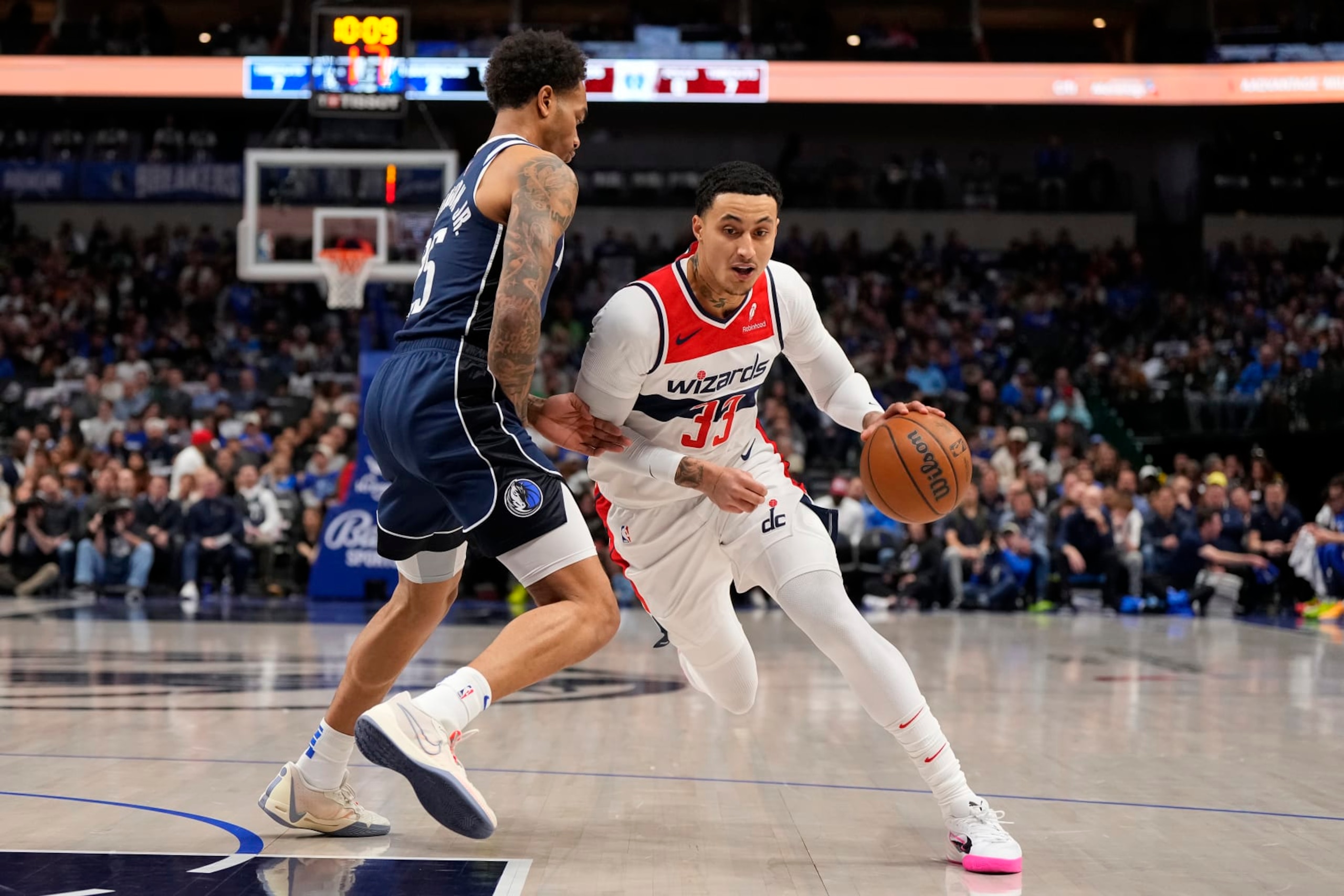DALLAS, TEXAS - FEBRUARY 12: Kyle Kuzma #33 of the Washington Wizards drives against P.J. Washington #25 of the Dallas Mavericks during the first half at American Airlines Center on February 12, 2024 in Dallas, Texas. NOTE TO USER: User expressly acknowledges and agrees that, by downloading and or using this photograph, User is consenting to the terms and conditions of the Getty Images License Agreement. (Photo by Sam Hodde/Getty Images)