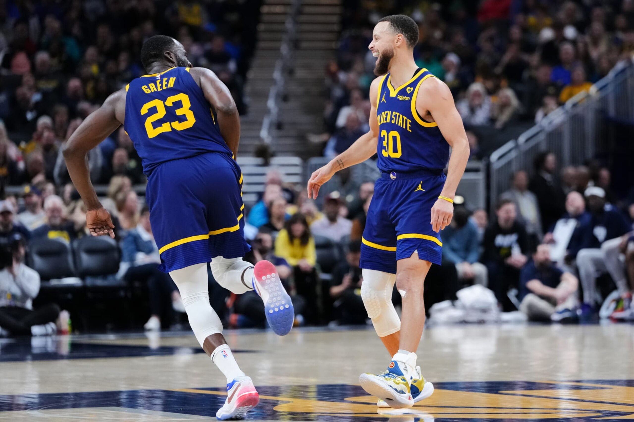 INDIANAPOLIS, INDIANA - FEBRUARY 08: Draymond Green #23 and Stephen Curry #30 of the Golden State Warriors celebrate in the fourth quarter against the Indiana Pacers at Gainbridge Fieldhouse on February 08, 2024 in Indianapolis, Indiana. NOTE TO USER: User expressly acknowledges and agrees that, by downloading and or using this photograph, User is consenting to the terms and conditions of the Getty Images License Agreement. (Photo by Dylan Buell/Getty Images)