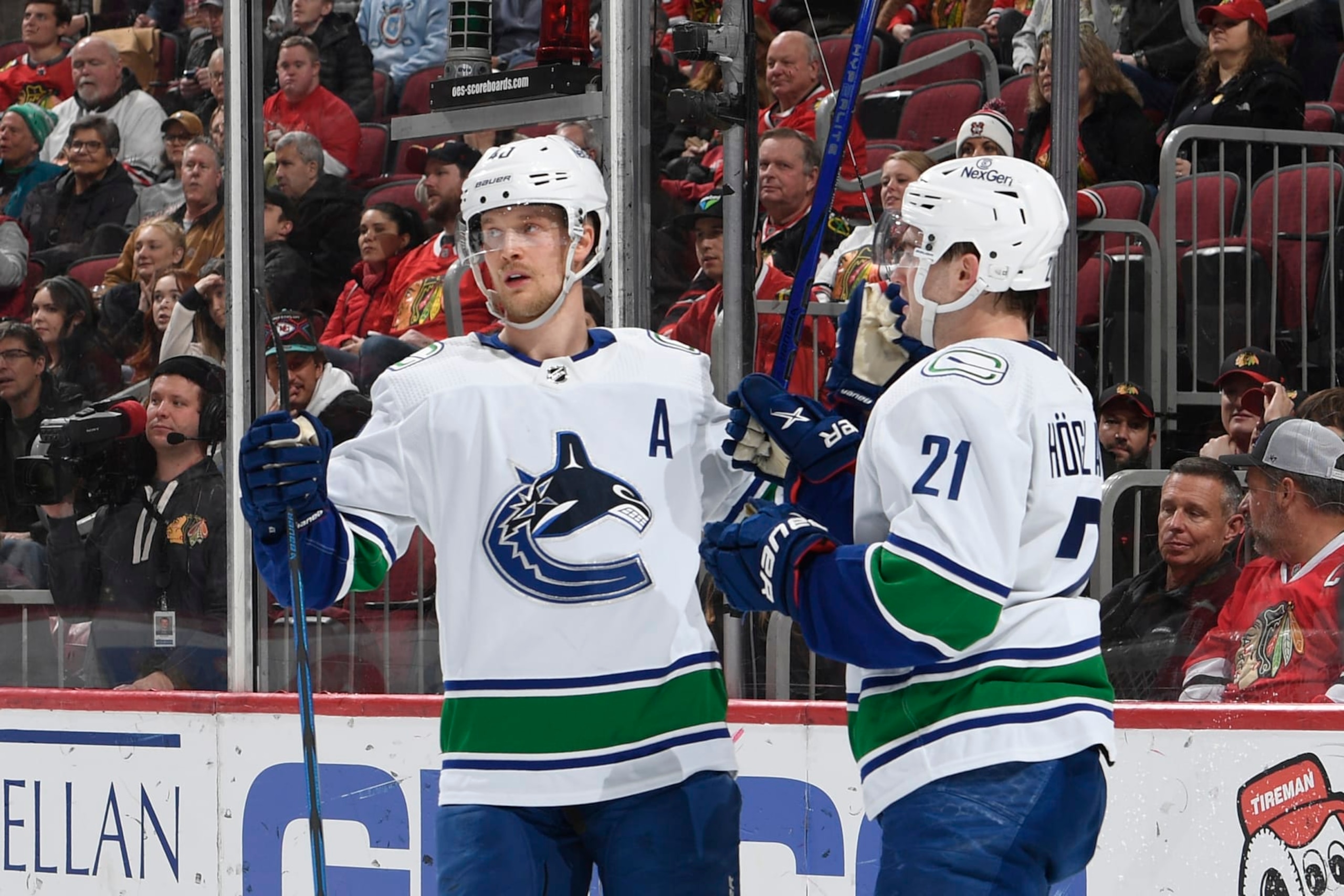 CHICAGO, ILLINOIS - FEBRUARY 13: Elias Pettersson #40 and Nils Hoglander #21 of the Vancouver Canucks celebrate after scoring against the Chicago Blackhawks in the second period at the United Center on February 13, 2024 in Chicago, Illinois. (Photo by Bill Smith/NHLI via Getty Images)