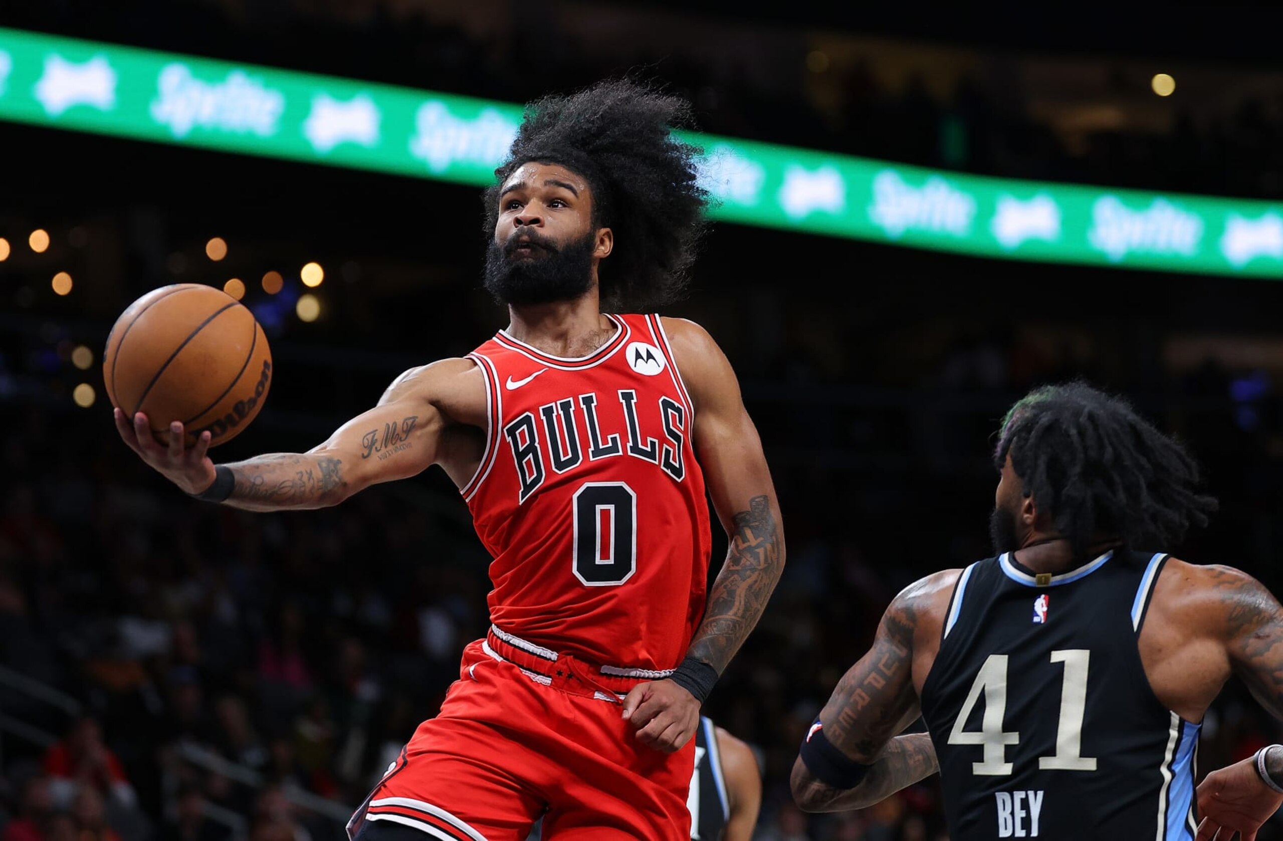 ATLANTA, GEORGIA - FEBRUARY 12:  Coby White #0 of the Chicago Bulls drives against Saddiq Bey #41 of the Atlanta Hawks during the fourth quarter at State Farm Arena on February 12, 2024 in Atlanta, Georgia.  NOTE TO USER: User expressly acknowledges and agrees that, by downloading and/or using this photograph, user is consenting to the terms and conditions of the Getty Images License Agreement.  (Photo by Kevin C. Cox/Getty Images)