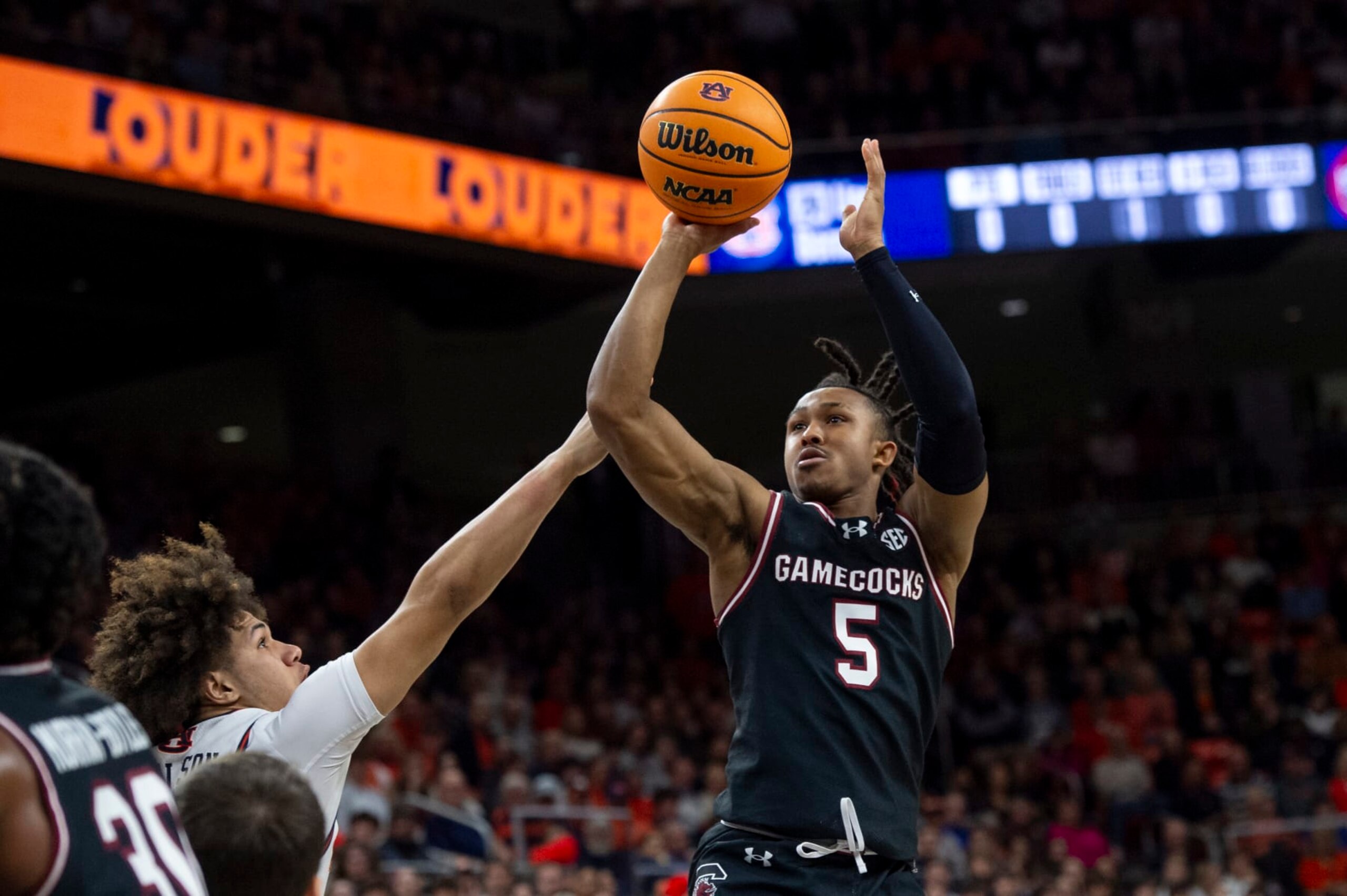 AUBURN, ALABAMA - FEBRUARY 14: Meechie Johnson #5 of the South Carolina Gamecocks looks to take a shot over Tre Donaldson #3 of the Auburn Tigers during the first half of play at Neville Arena on February 14, 2024 in Auburn, Alabama. (Photo by Michael Chang/Getty Images)