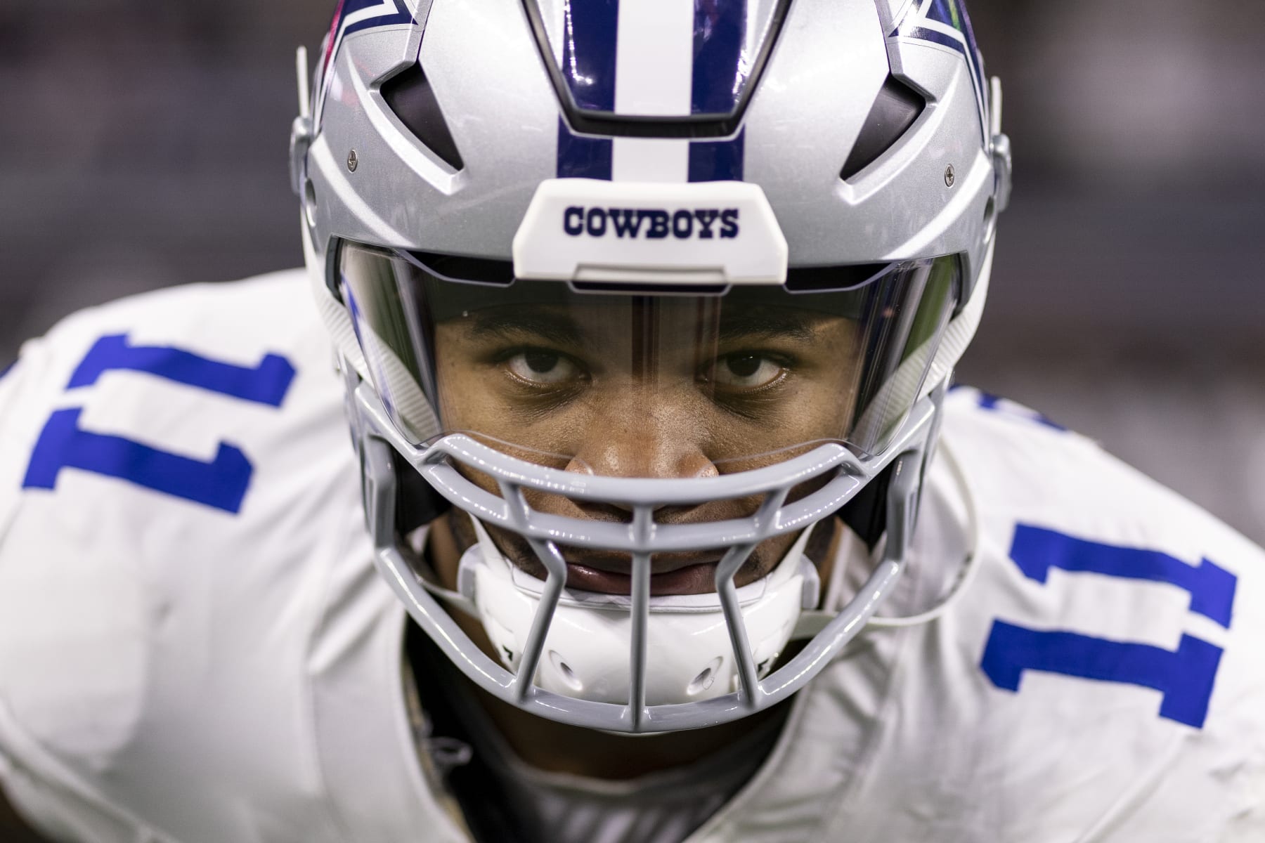 ARLINGTON, TEXAS - JANUARY 14: Micah Parsons #11 of the Dallas Cowboys looks on as he stretches prior to an NFL wild-card playoff football game between the Dallas Cowboys and the Green Bay Packers at AT&T Stadium on January 14, 2024 in Arlington, Texas. (Photo by Michael Owens/Getty Images)