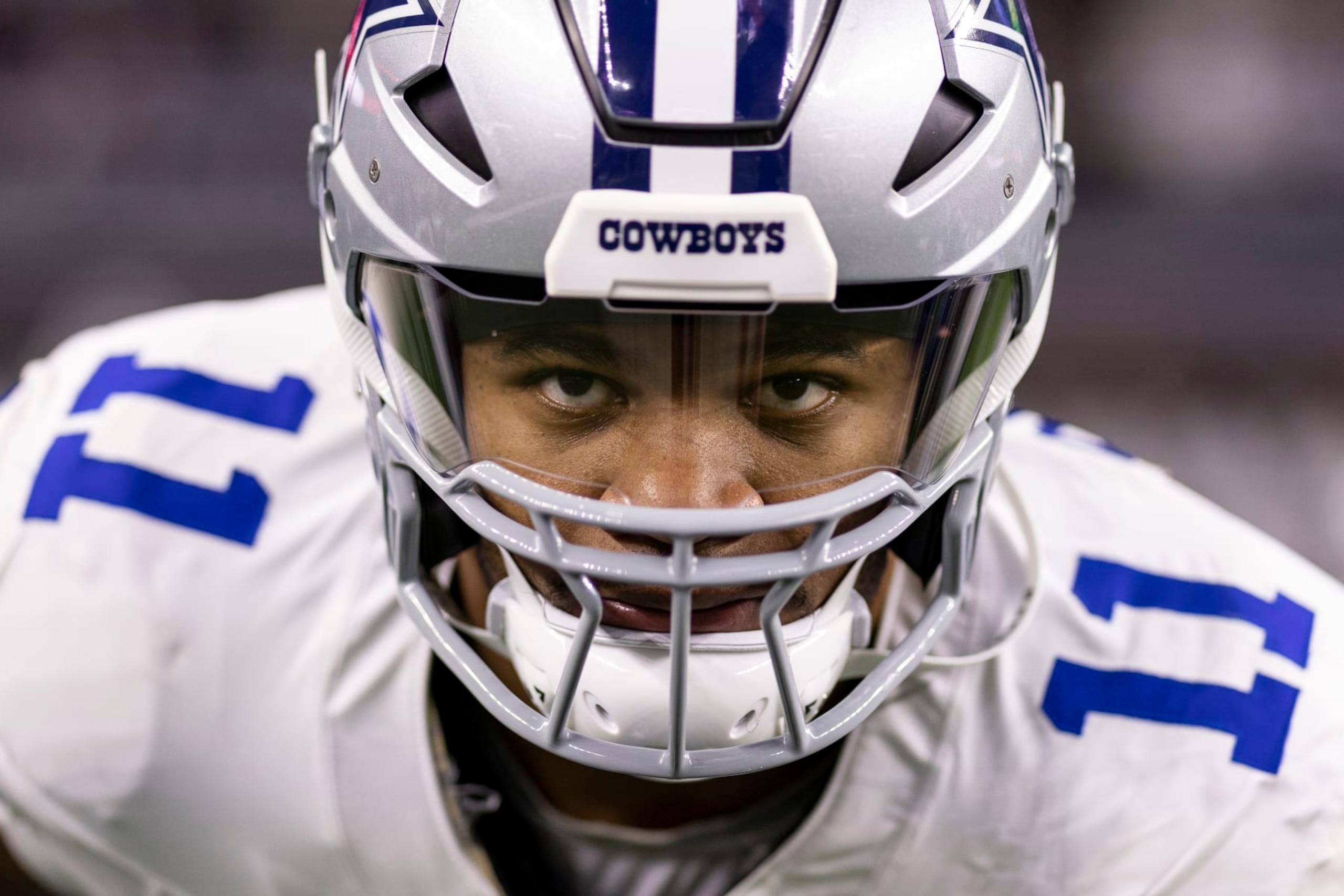 ARLINGTON, TEXAS - JANUARY 14: Micah Parsons #11 of the Dallas Cowboys looks on as he stretches prior to an NFL wild-card playoff football game between the Dallas Cowboys and the Green Bay Packers at AT&T Stadium on January 14, 2024 in Arlington, Texas. (Photo by Michael Owens/Getty Images)