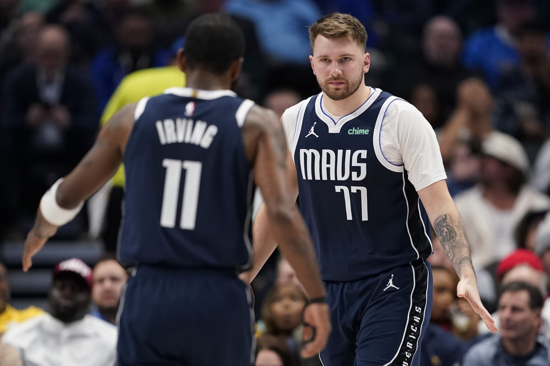 DALLAS, TEXAS - FEBRUARY 12: Luka Doncic #77 of the Dallas Mavericks greets Kyrie Irving #11 during the first half against the Washington Wizards at American Airlines Center on February 12, 2024 in Dallas, Texas. NOTE TO USER: User expressly acknowledges and agrees that, by downloading and or using this photograph, User is consenting to the terms and conditions of the Getty Images License Agreement. (Photo by Sam Hodde/Getty Images)