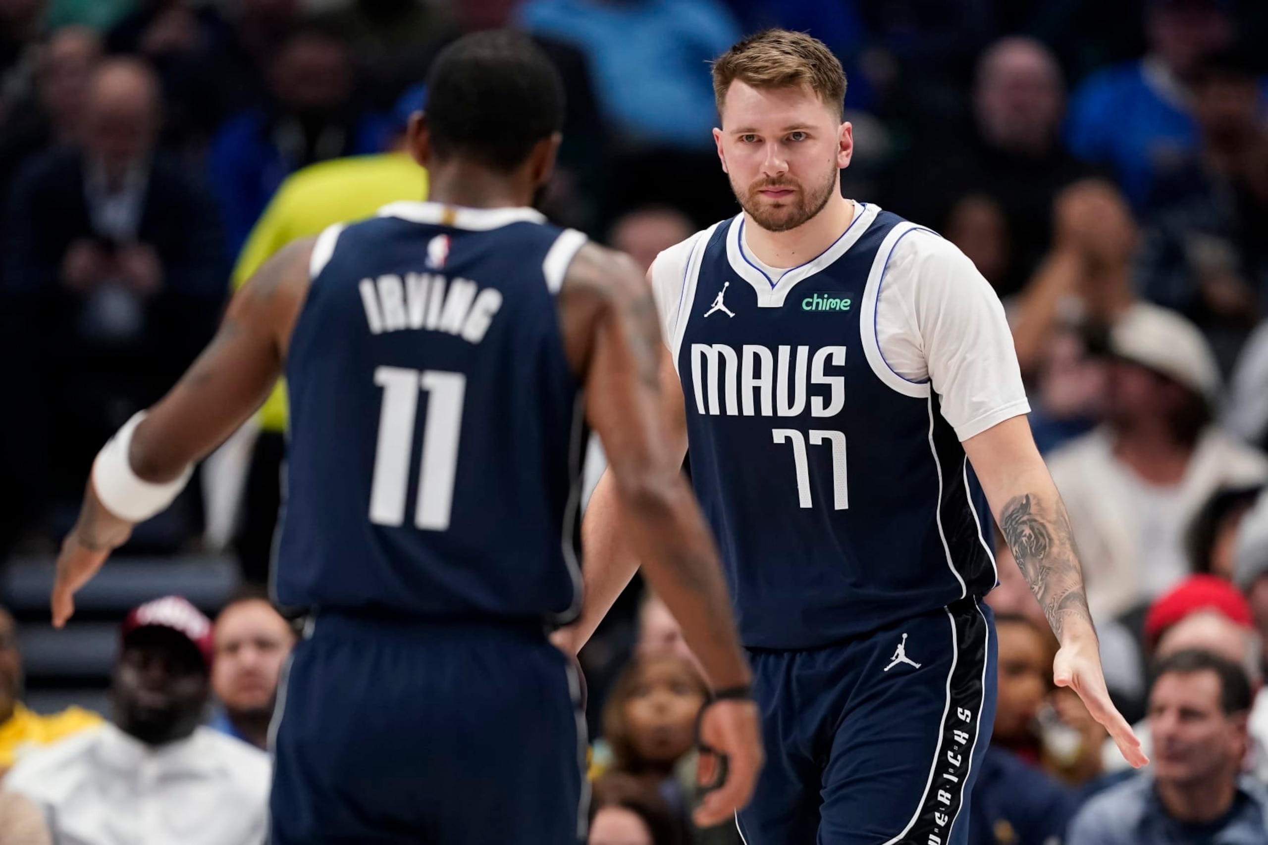 DALLAS, TEXAS - FEBRUARY 12: Luka Doncic #77 of the Dallas Mavericks greets Kyrie Irving #11 during the first half against the Washington Wizards at American Airlines Center on February 12, 2024 in Dallas, Texas. NOTE TO USER: User expressly acknowledges and agrees that, by downloading and or using this photograph, User is consenting to the terms and conditions of the Getty Images License Agreement. (Photo by Sam Hodde/Getty Images)