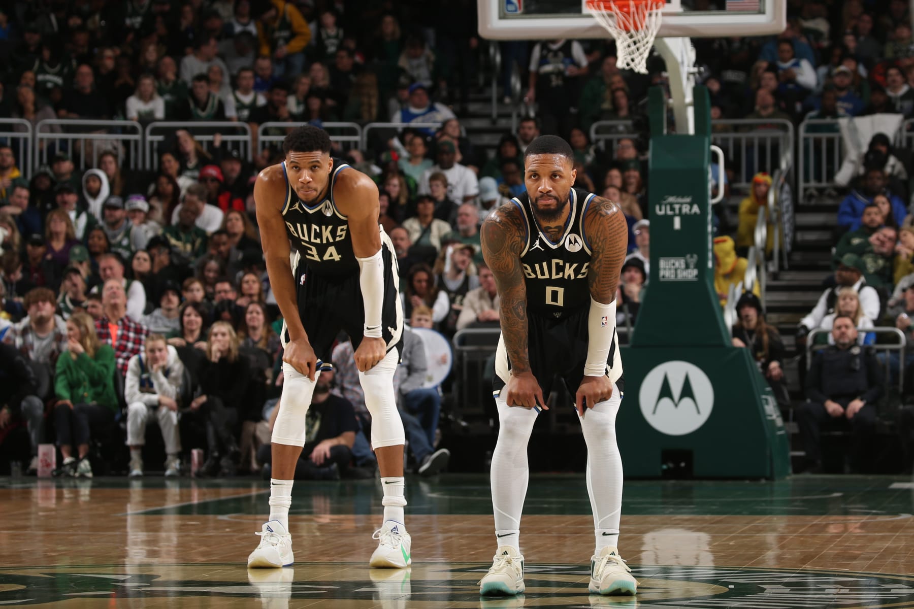 MILWAUKEE, WI - JANUARY 26:  Giannis Antetokounmpo #34 and Damian Lillard #0 of the Milwaukee Bucks look on during the game against the Cleveland Cavaliers on January 26, 2024 at the Fiserv Forum Center in Milwaukee, Wisconsin. NOTE TO USER: User expressly acknowledges and agrees that, by downloading and or using this Photograph, user is consenting to the terms and conditions of the Getty Images License Agreement. Mandatory Copyright Notice: Copyright 2024 NBAE (Photo by Gary Dineen/NBAE via Getty Images).