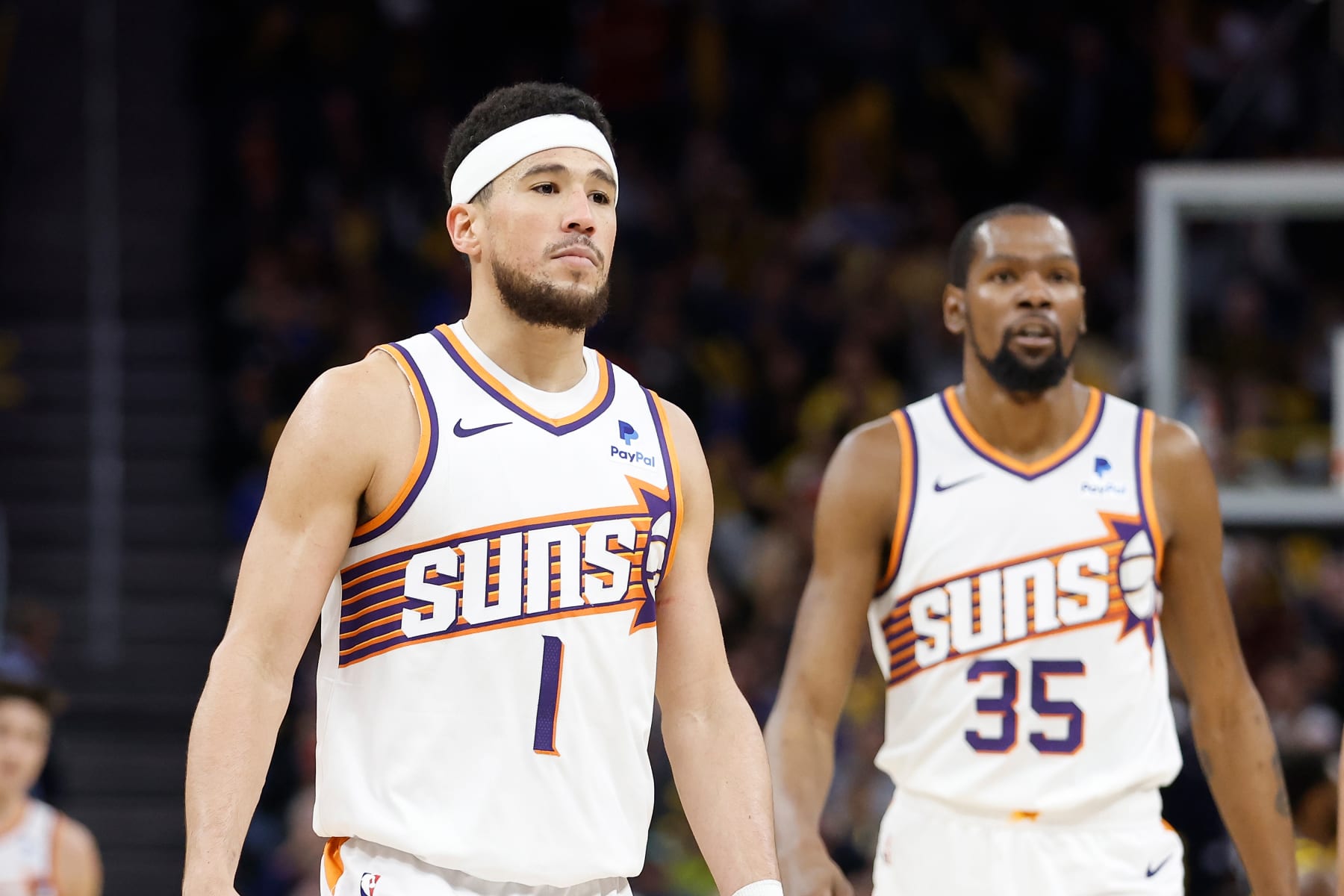 SAN FRANCISCO, CALIFORNIA - FEBRUARY 10: Devin Booker #1 and Kevin Durant #35 of the Phoenix Suns looks on during the game against the Golden State Warriors at Chase Center on February 10, 2024 in San Francisco, California. NOTE TO USER: User expressly acknowledges and agrees that, by downloading and or using this photograph, User is consenting to the terms and conditions of the Getty Images License Agreement. (Photo by Lachlan Cunningham/Getty Images)