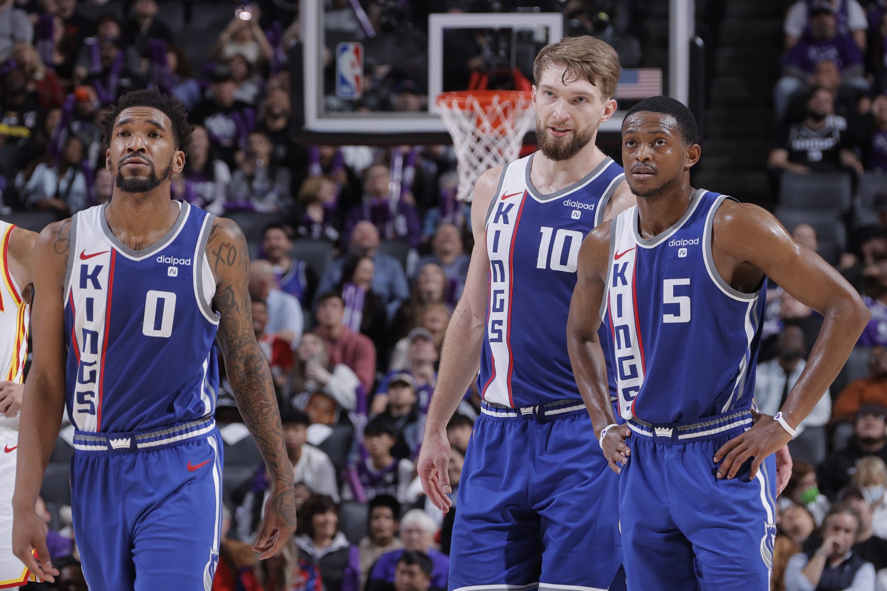 SACRAMENTO, CA - JANUARY 22: Malik Monk #0, Domantas Sabonis #10 and De'Aaron Fox #5 of the Sacramento Kings looks on during the game against the Atlanta Hawks on January 22, 2024 at Golden 1 Center in Sacramento, California. NOTE TO USER: User expressly acknowledges and agrees that, by downloading and or using this Photograph, user is consenting to the terms and conditions of the Getty Images License Agreement. Mandatory Copyright Notice: Copyright 2024 NBAE (Photo by Rocky Widner/NBAE via Getty Images)