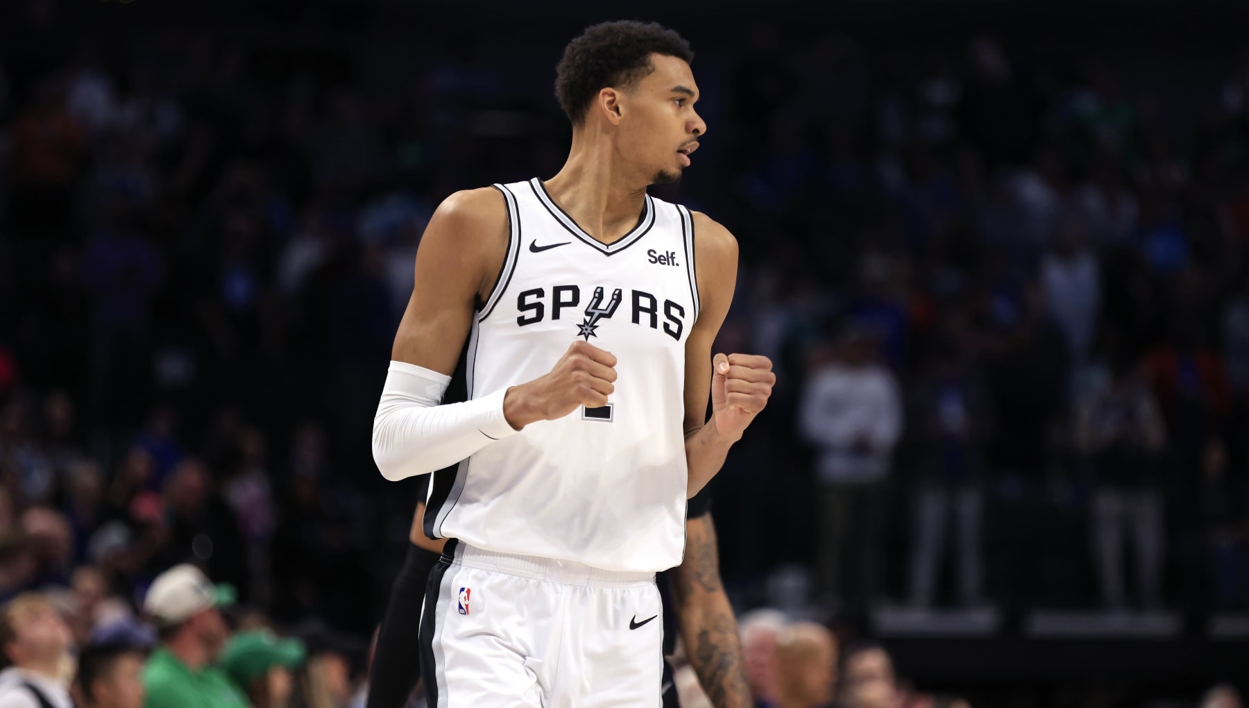 DALLAS, TX - FEBRUARY 14: Victor Wembanyama #1 of the San Antonio Spurs reacts after scoring a three point basket against the Dallas Mavericks in the first half at American Airlines Center on February 14, 2024 in Dallas, Texas. NOTE TO USER: User expressly acknowledges and agrees that, by downloading and or using this photograph, User is consenting to the terms and conditions of the Getty Images License Agreement. (Photo by Ron Jenkins/Getty Images)