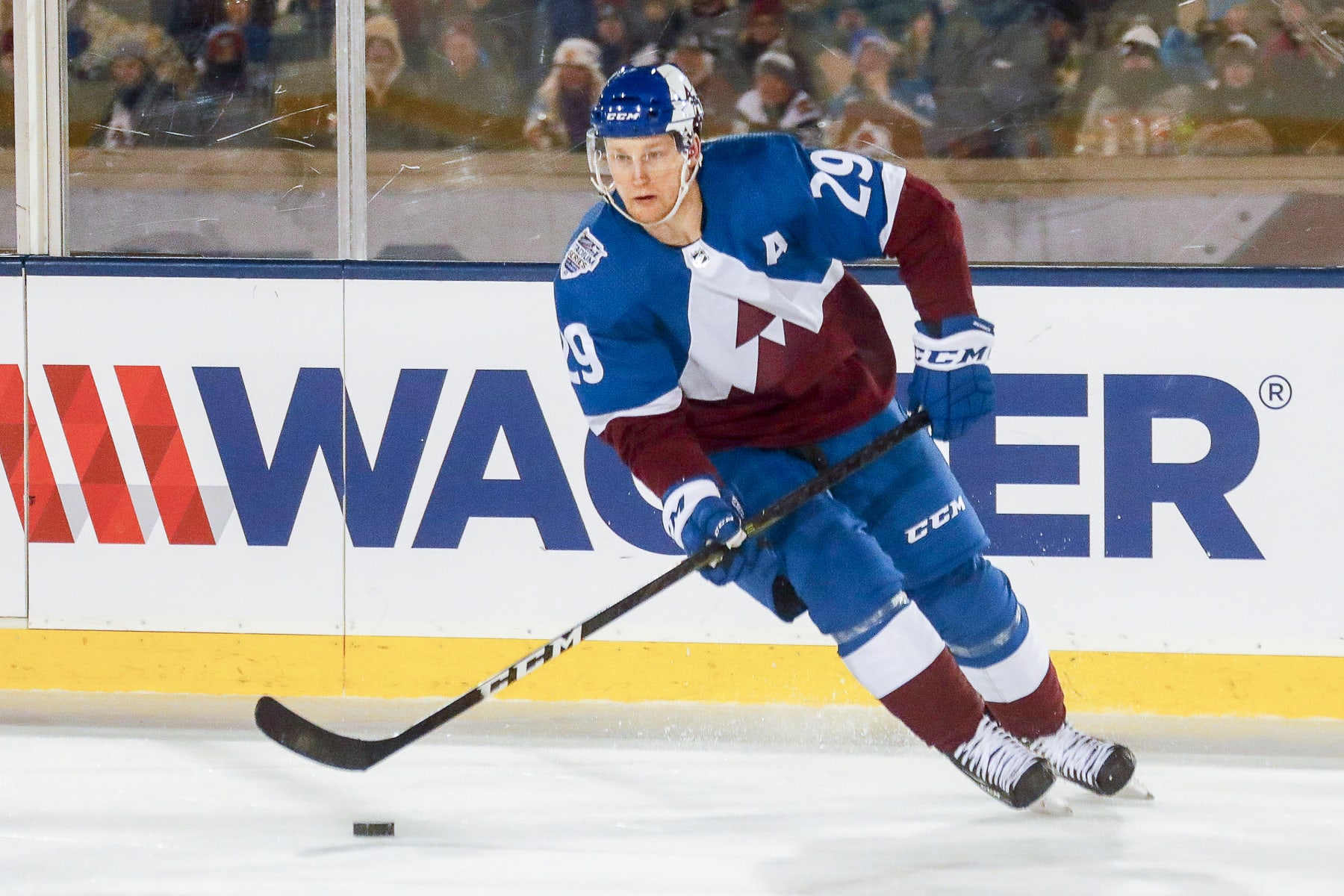 COLORADO SPRINGS, CO - FEBRUARY 15: Colorado Avalanche center Nathan MacKinnon (29) skates with the puck during the Los Angeles Kings and Colorado Avalanche NHL Stadium Series game on February 15, 2020, at Falcon Stadium in Colorado Springs, CO. (Photo by John Crouch/Icon Sportswire via Getty Images)