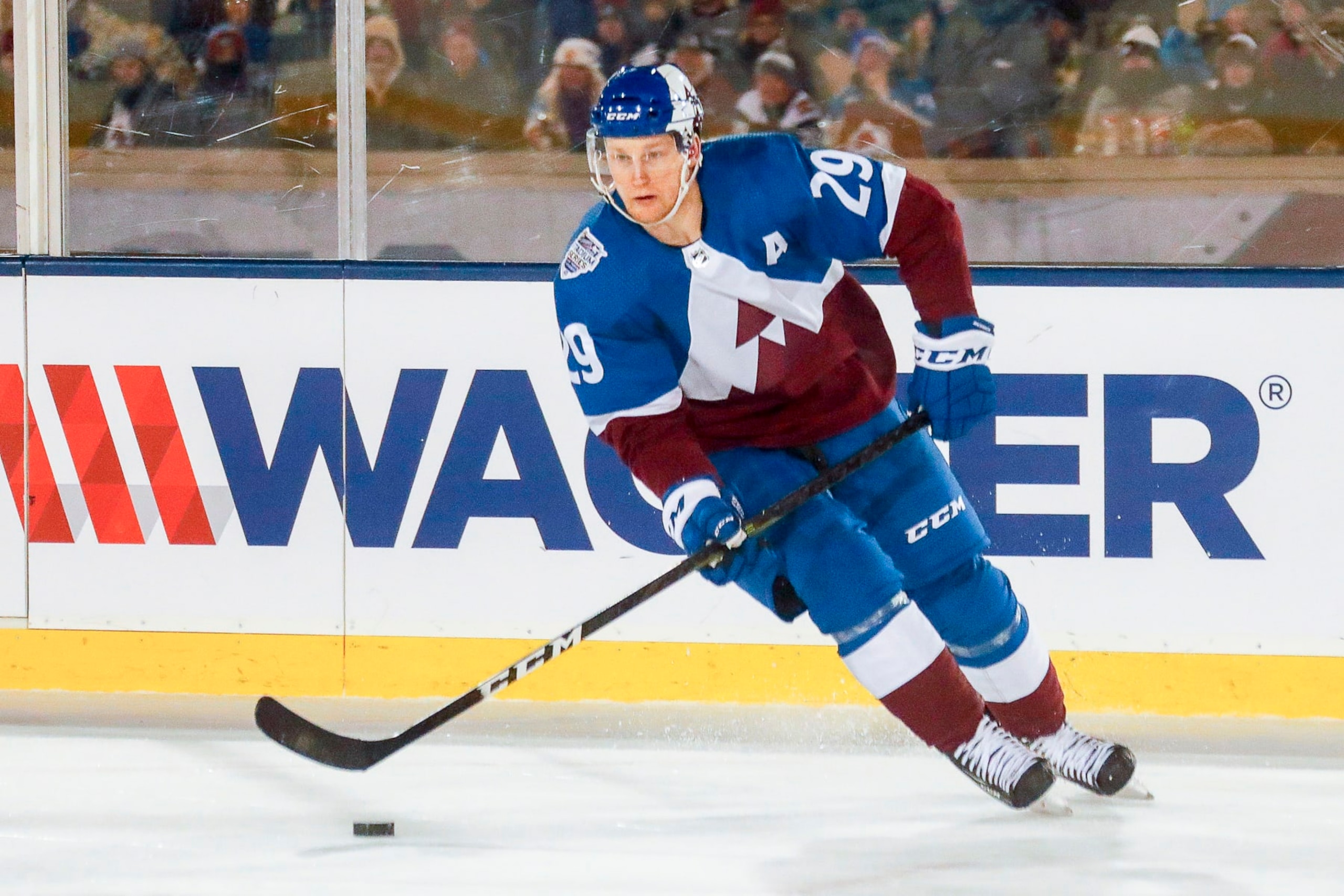 COLORADO SPRINGS, CO - FEBRUARY 15: Colorado Avalanche center Nathan MacKinnon (29) skates with the puck during the Los Angeles Kings and Colorado Avalanche NHL Stadium Series game on February 15, 2020, at Falcon Stadium in Colorado Springs, CO. (Photo by John Crouch/Icon Sportswire via Getty Images) COLORADO SPRINGS, CO - FEBRUARY 15: Colorado Avalanche center Nathan MacKinnon (29) skates with the puck during the Los Angeles Kings and Colorado Avalanche NHL Stadium Series game on February 15, 2020, at Falcon Stadium in Colorado Springs, CO. (Photo by John Crouch/Icon Sportswire via Getty Images)