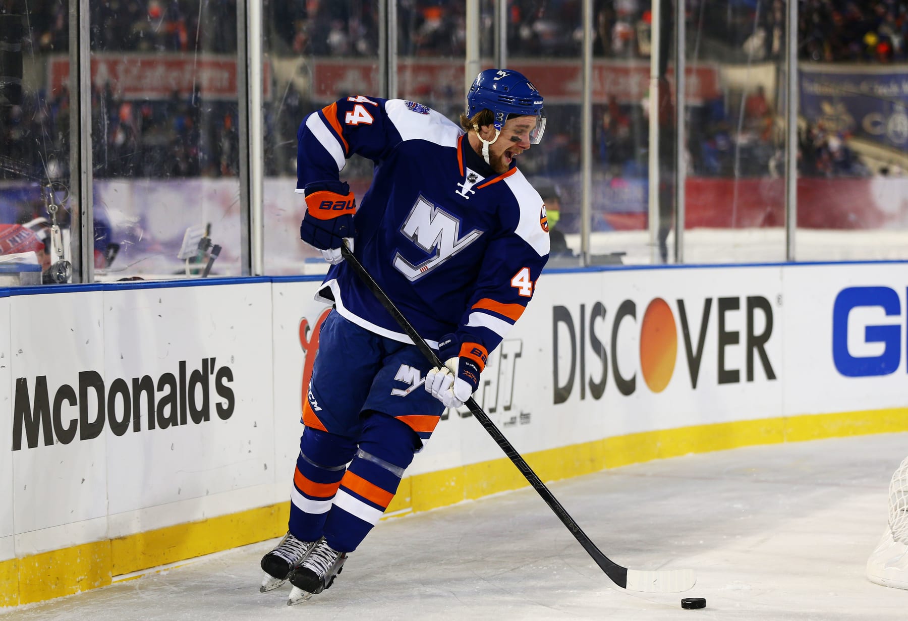 NEW YORK, NY - JANUARY 29:  (EDITORIAL USE ONLY)  Calvin de Haan #44 of the New York Islanders controls the puck against the New York Rangers during the 2014 Coors Light NHL Stadium Series at Yankee Stadium on January 29, 2014 in New York City.  (Photo by Elsa/Getty Images) 