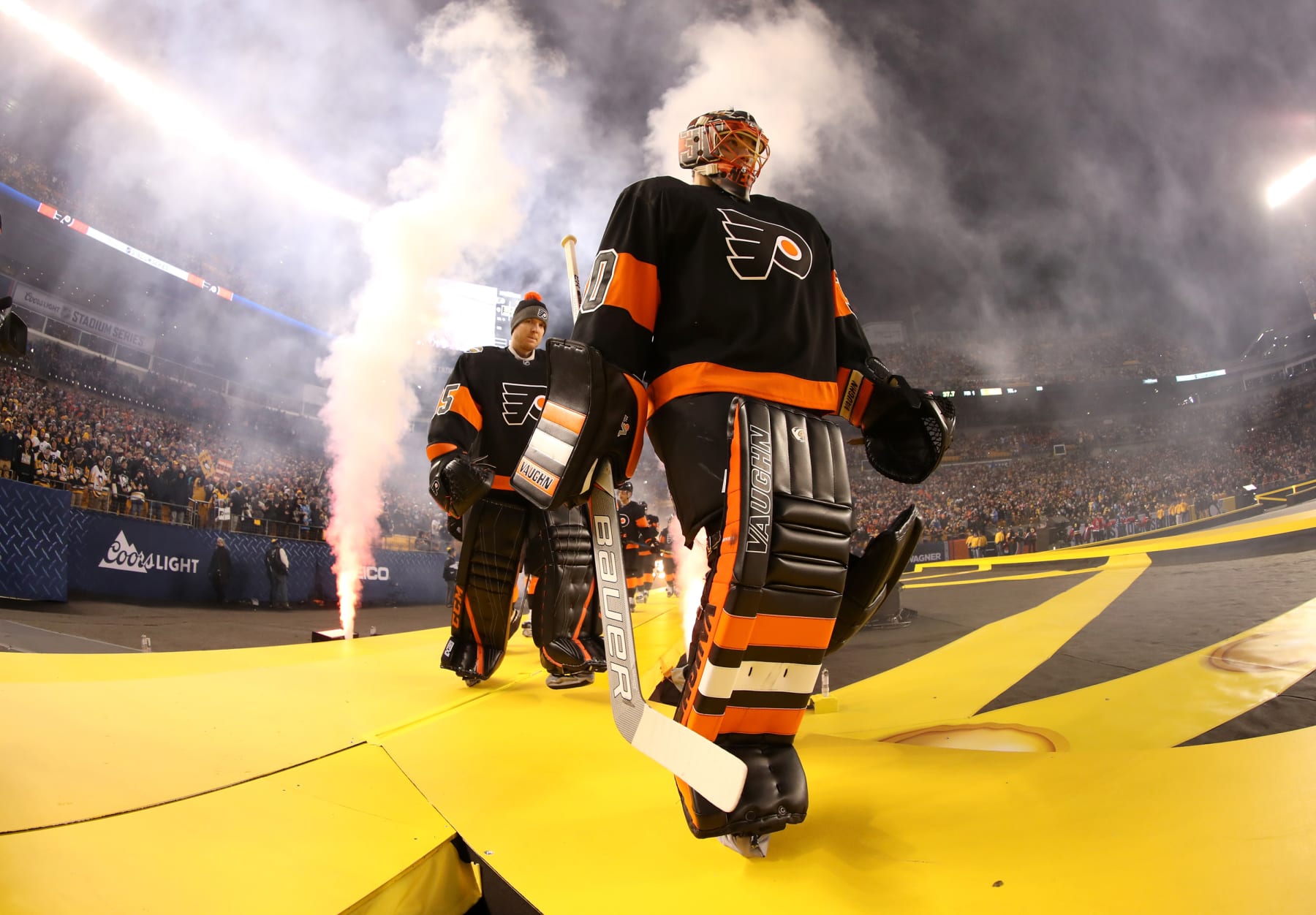 PITTSBURGH, PA - FEBRUARY 25: Goaltenders Steve Mason #35 and Michal Neuvirth #30 of the Philadelphia Flyers make their way to their team bench for the  2017 Coors Light NHL Stadium Series against the Pittsburgh Penguins at Heinz Field on February 25, 2017 in Pittsburgh, Pennsylvania.  (Photo by Len Redkoles/NHLI via Getty Images)