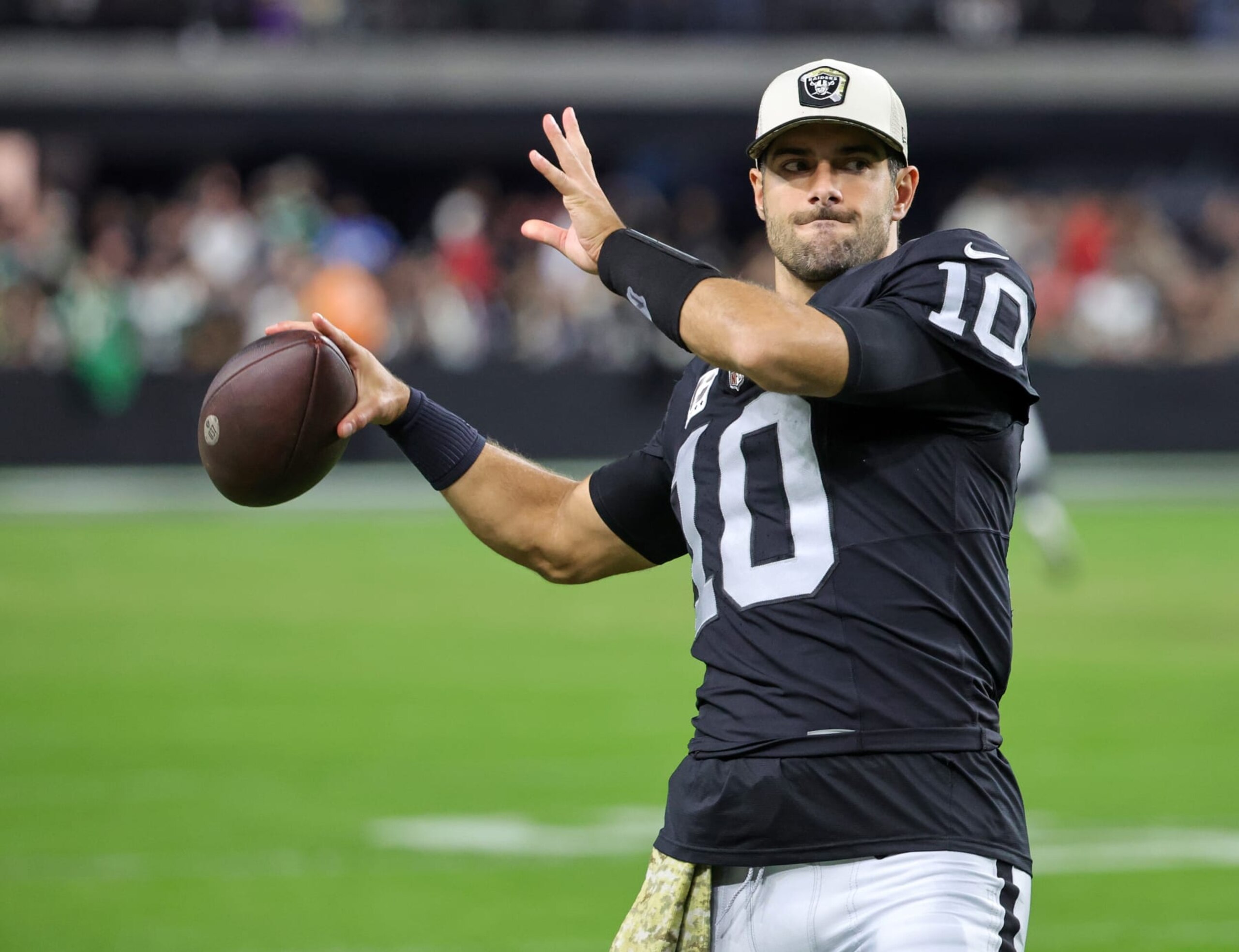 LAS VEGAS, NEVADA - NOVEMBER 12: Quarterback Jimmy Garoppolo #10 of the Las Vegas Raiders helps warm up teammate Aidan O'Connell #4 before the start of the third quarter of their game against the New York Jets at Allegiant Stadium on November 12, 2023 in Las Vegas, Nevada. The Raiders defeated the Jets 16-12. (Photo by Ethan Miller/Getty Images)