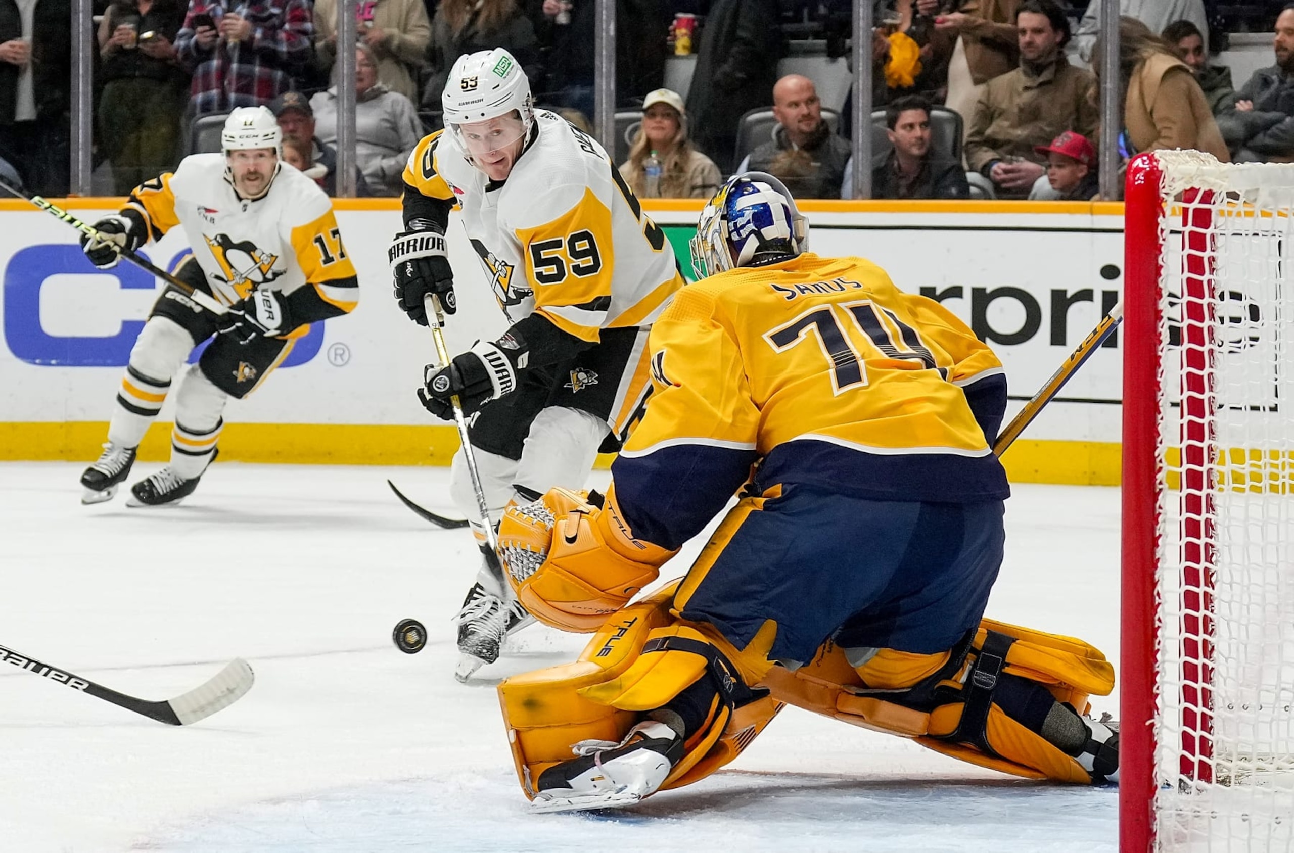 Pittsburgh Penguins winger Jake Guentzel (59) attempts to score on Nashville Predators goaltender Juuse Saros. 