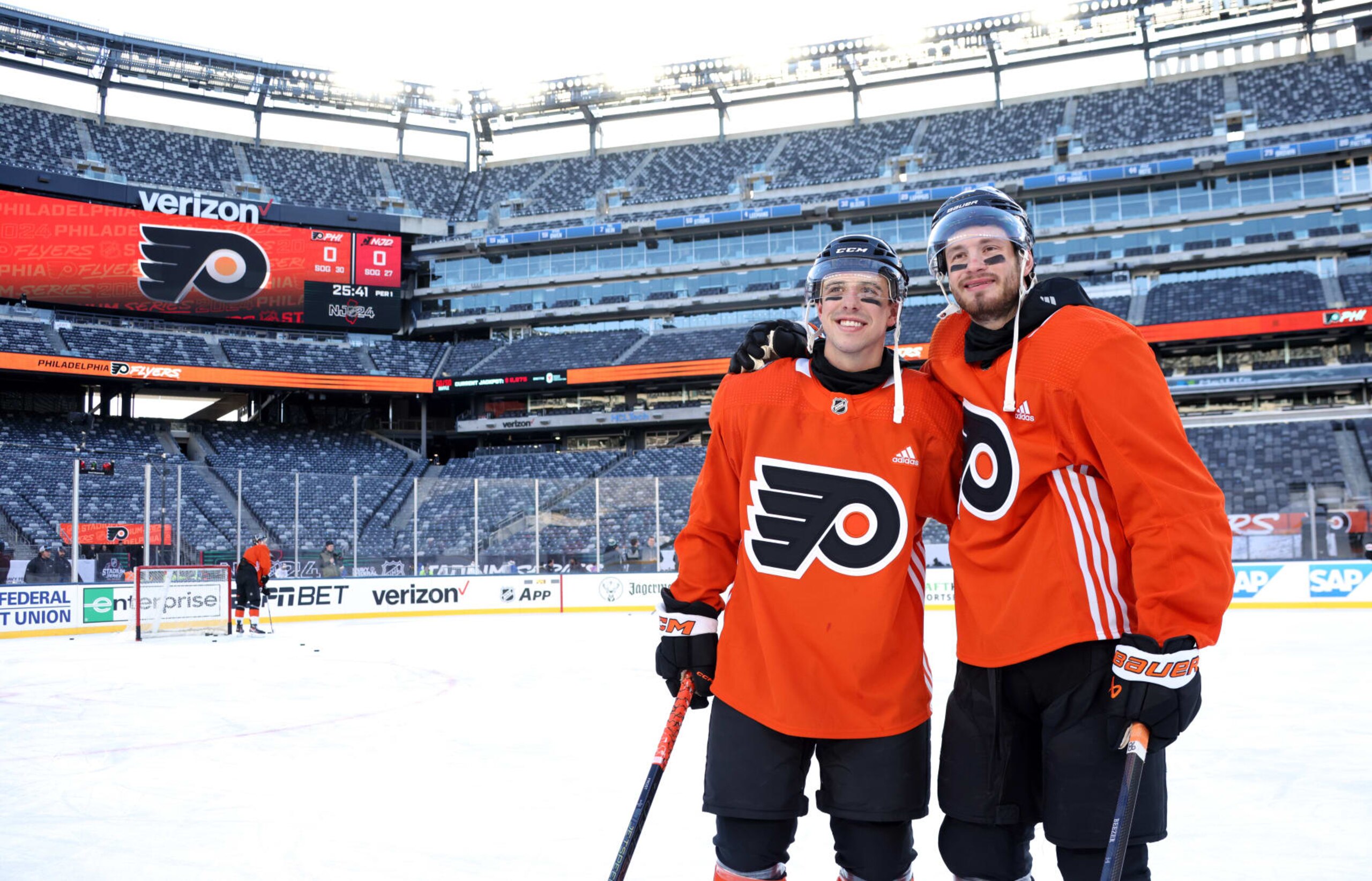 EAST RUTHERFORD, NEW JERSEY - FEBRUARY 16: Morgan Frost #48 and Joel Farabee #86 of the Philadelphia Flyers pose for a photo before practice at MetLife Stadium on February 16, 2024 in East Rutherford, New Jersey. (Photo by Dave Sandford/NHLI via Getty Images)