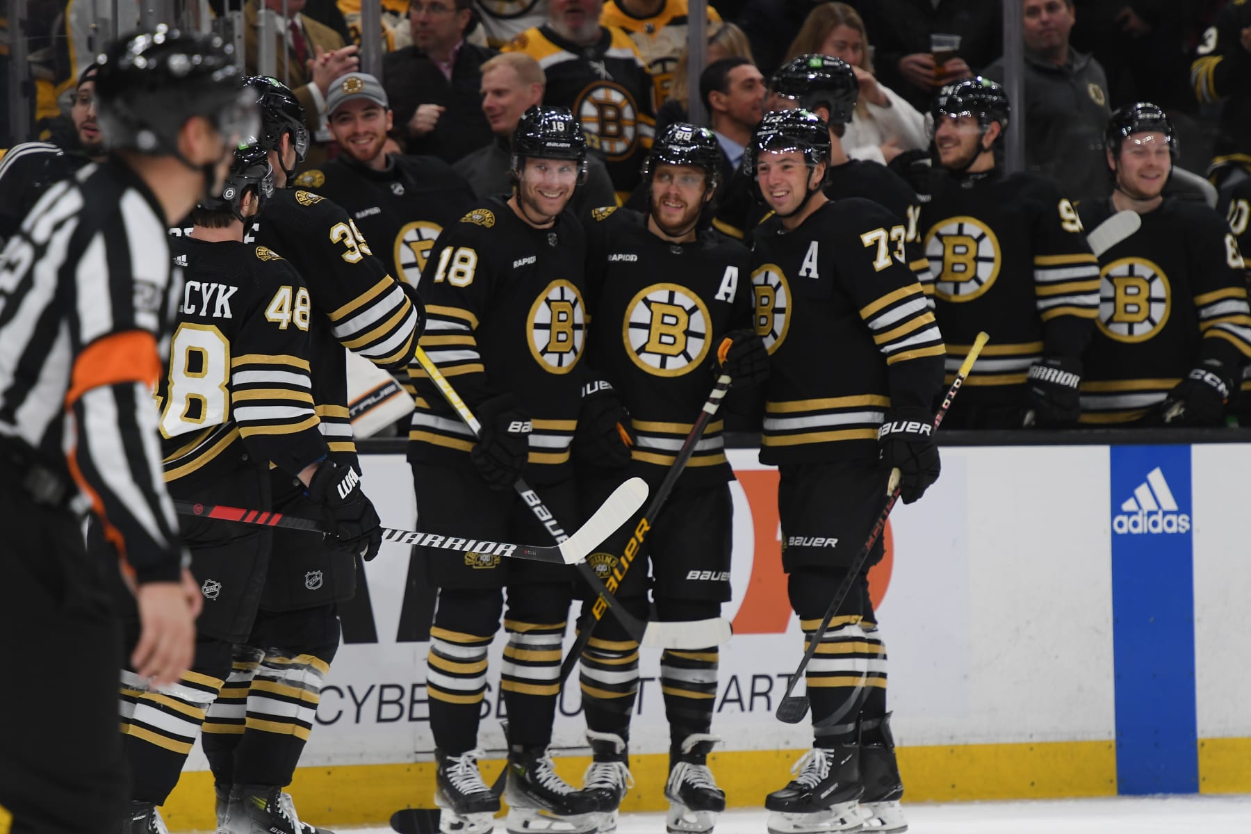 BOSTON, MASSACHUSETTS - FEBRUARY 8: Pavel Zacha #18, David Pastrnak #88 and Charlie McAvoy #73 of the Boston Bruins smile after the second-period goal against the Vancouver Canucks at the TD Garden on February 8, 2024 in Boston, Massachusetts. (Photo by Steve Babineau/NHLI via Getty Images)