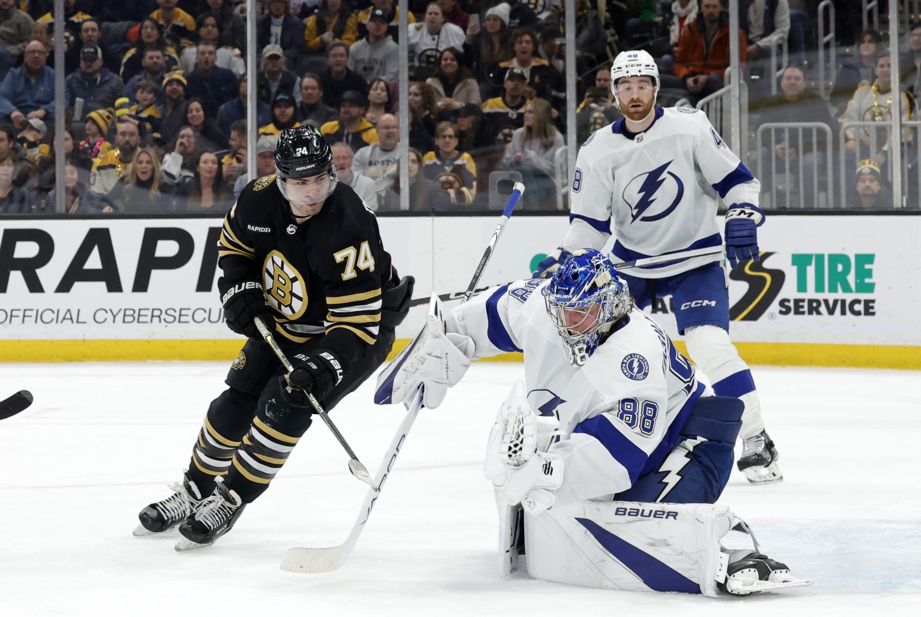 BOSTON, MA - FEBRUARY 13: Tampa Bay Lightning goalie Andrei Vasilevskiy (88) gloves a shot in front of Boston Bruins left wing Jake DeBrusk (74) during a game between the Boston Bruins and the Tampa Bay Lightning on February 13, 2024, at TD Garden in Boston, Massachusetts. (Photo by Fred Kfoury III/Icon Sportswire via Getty Images)