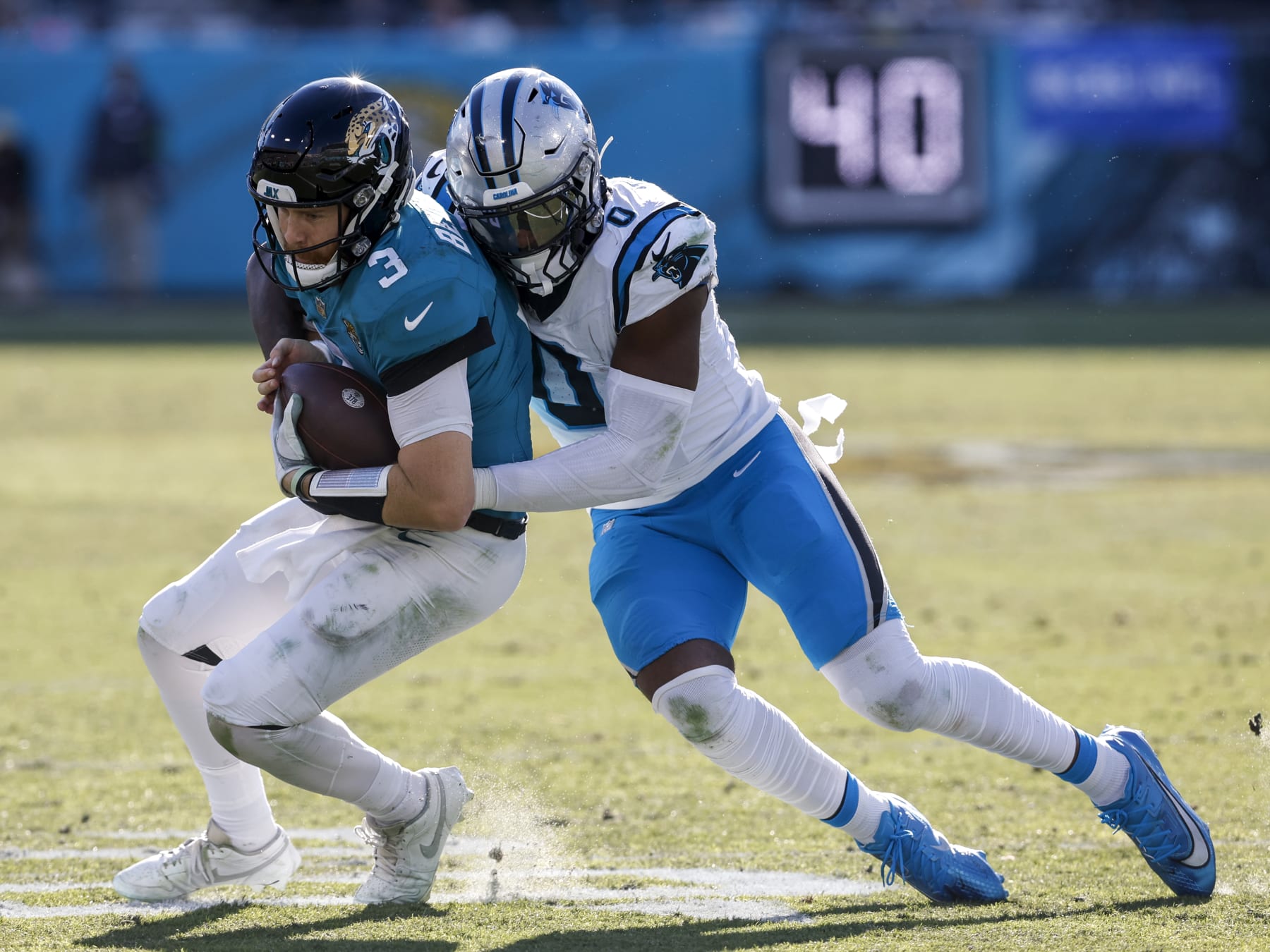 JACKSONVILLE, FL - DECEMBER 31: Quarterback C.J. Beathard #3 of the Jacksonville Jaguars is sacked by Linebacker Brian Burns #0 of the Carolina Panthers during the game at EverBank Stadium on December 31, 2023 in Jacksonville, Florida. The Jaguars defeated the Panthers 26 to 0. (Photo by Don Juan Moore/Getty Images)