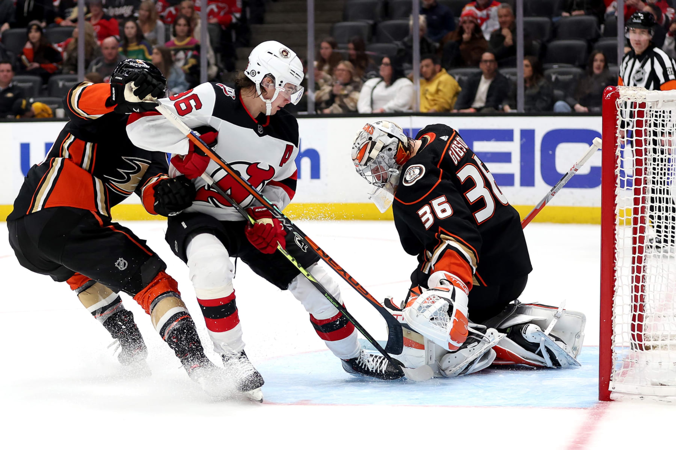 ANAHEIM, CALIFORNIA - JANUARY 13: Cam Fowler #4 and John Gibson #36 of the Anaheim Ducks are unable to defend against a goal by Jack Hughes #86 of the New Jersey Devils during the third period of a game at Honda Center on January 13, 2023 in Anaheim, California. (Photo by Sean M. Haffey/Getty Images)