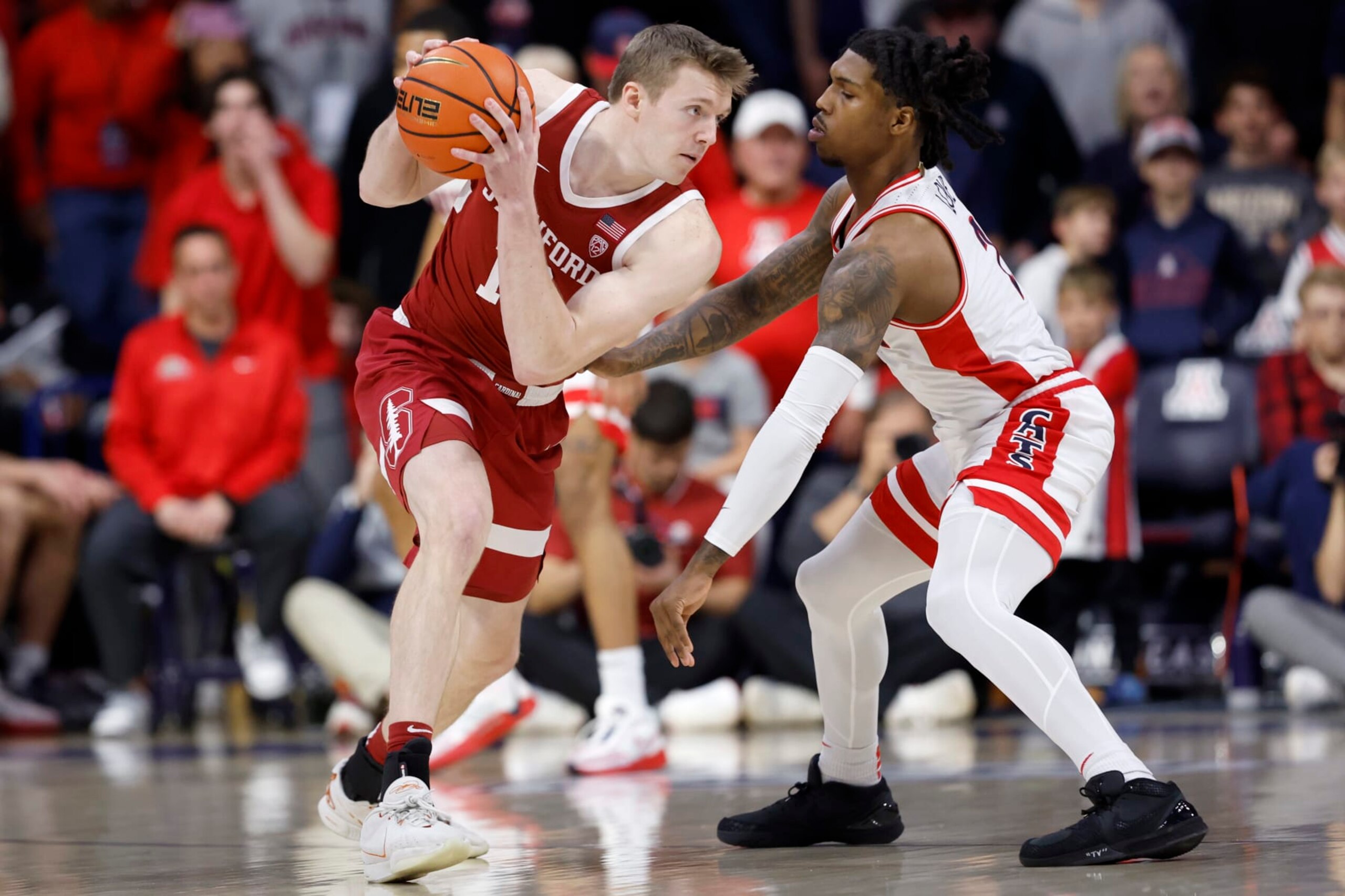 TUCSON, ARIZONA - FEBRUARY 04: Michael Jones #13 of the Stanford Cardinal controls the ball against Caleb Love #2 of the Arizona Wildcats during the first half at McKale Center on February 04, 2024 in Tucson, Arizona. (Photo by Chris Coduto/Getty Images) TUCSON, ARIZONA - FEBRUARY 04: Michael Jones #13 of the Stanford Cardinal controls the ball against Caleb Love #2 of the Arizona Wildcats during the first half at McKale Center on February 04, 2024 in Tucson, Arizona. (Photo by Chris Coduto/Getty Images)