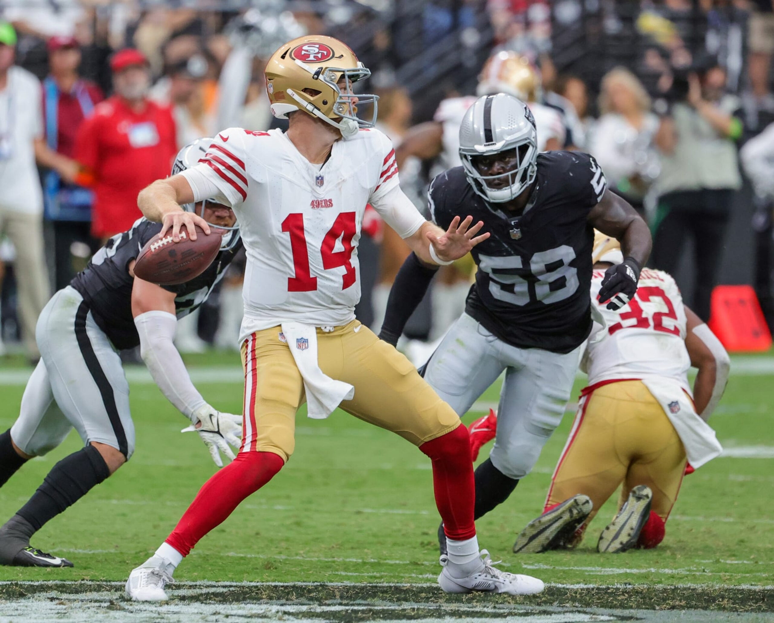 LAS VEGAS, NEVADA - AUGUST 13: Quarterback Sam Darnold #14 of the San Francisco 49ers throws under pressure from linebacker Darien Butler #58 of the Las Vegas Raiders in the fourth quarter of a preseason game at Allegiant Stadium on August 13, 2023 in Las Vegas, Nevada. The Raiders defeated the 49ers 34-7. (Photo by Ethan Miller/Getty Images)
