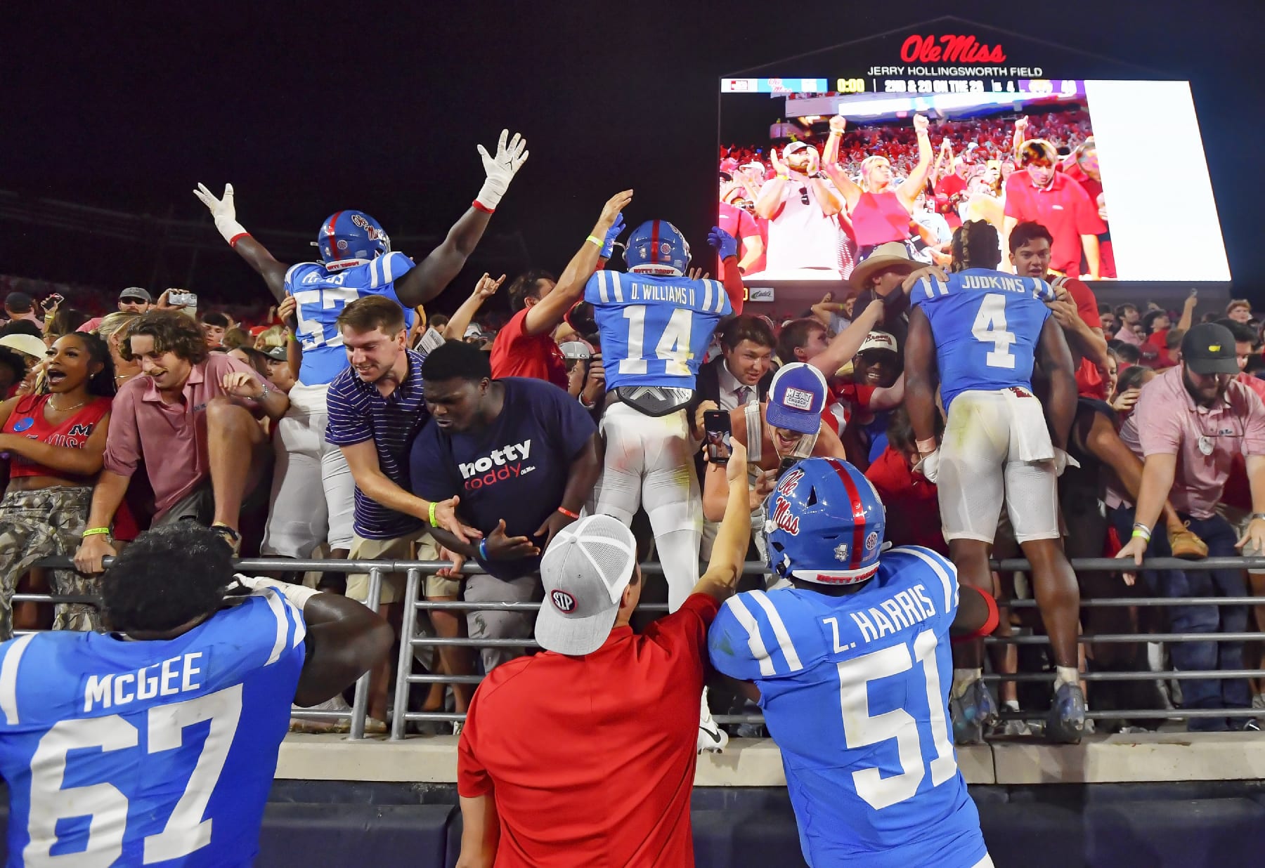Mississippi Rebels players celebrate with fans after a win over LSU.