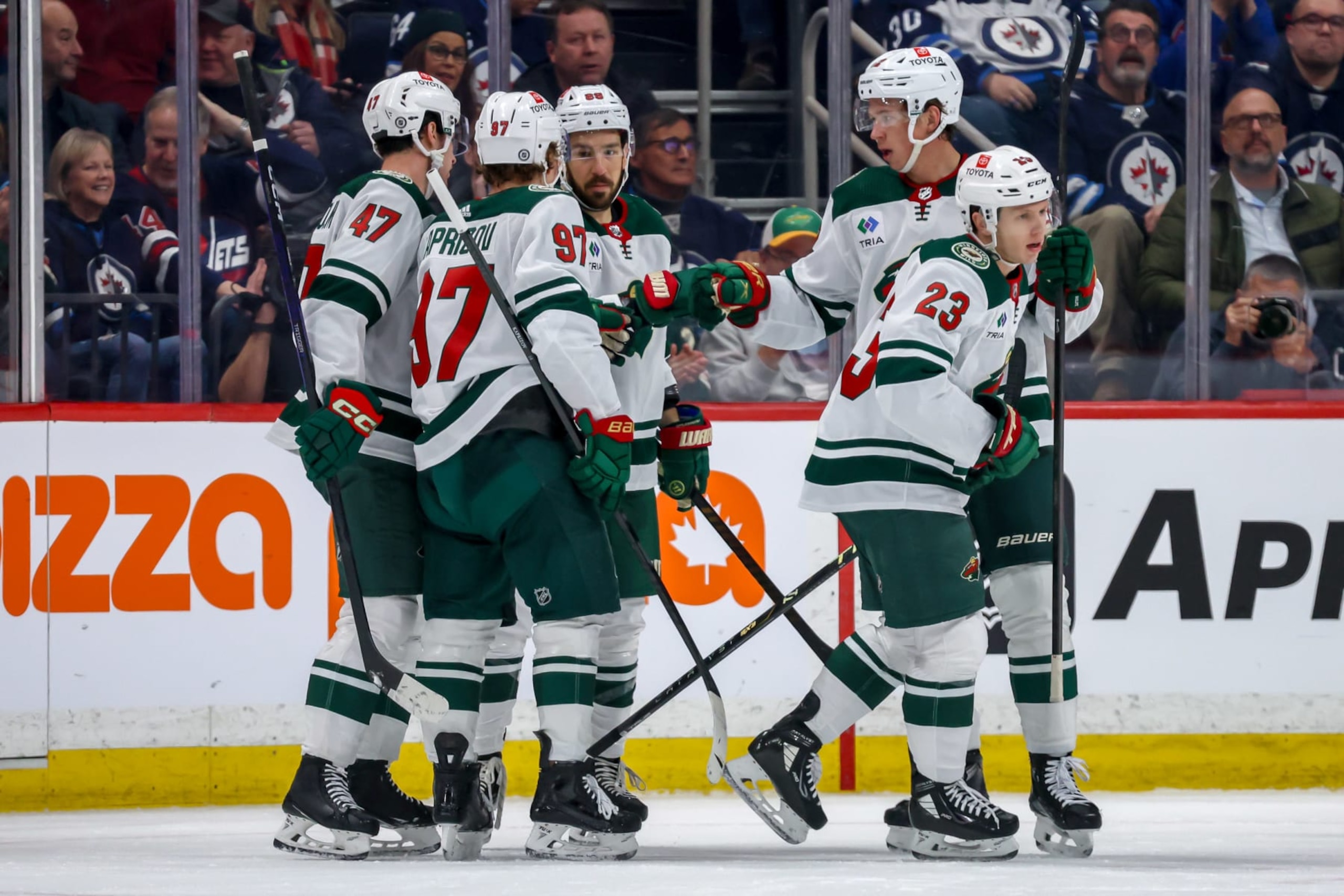 WINNIPEG, CANADA - FEBRUARY 20: Declan Chisholm #47, Kirill Kaprizov #97, Frederick Gaudreau #89, Matt Boldy #12 and Marco Rossi #23 of the Minnesota Wild celebrate a second period goal against the Winnipeg Jets at the Canada Life Centre on February 20, 2024 in Winnipeg, Manitoba, Canada. (Photo by Jonathan Kozub/NHLI via Getty Images)
