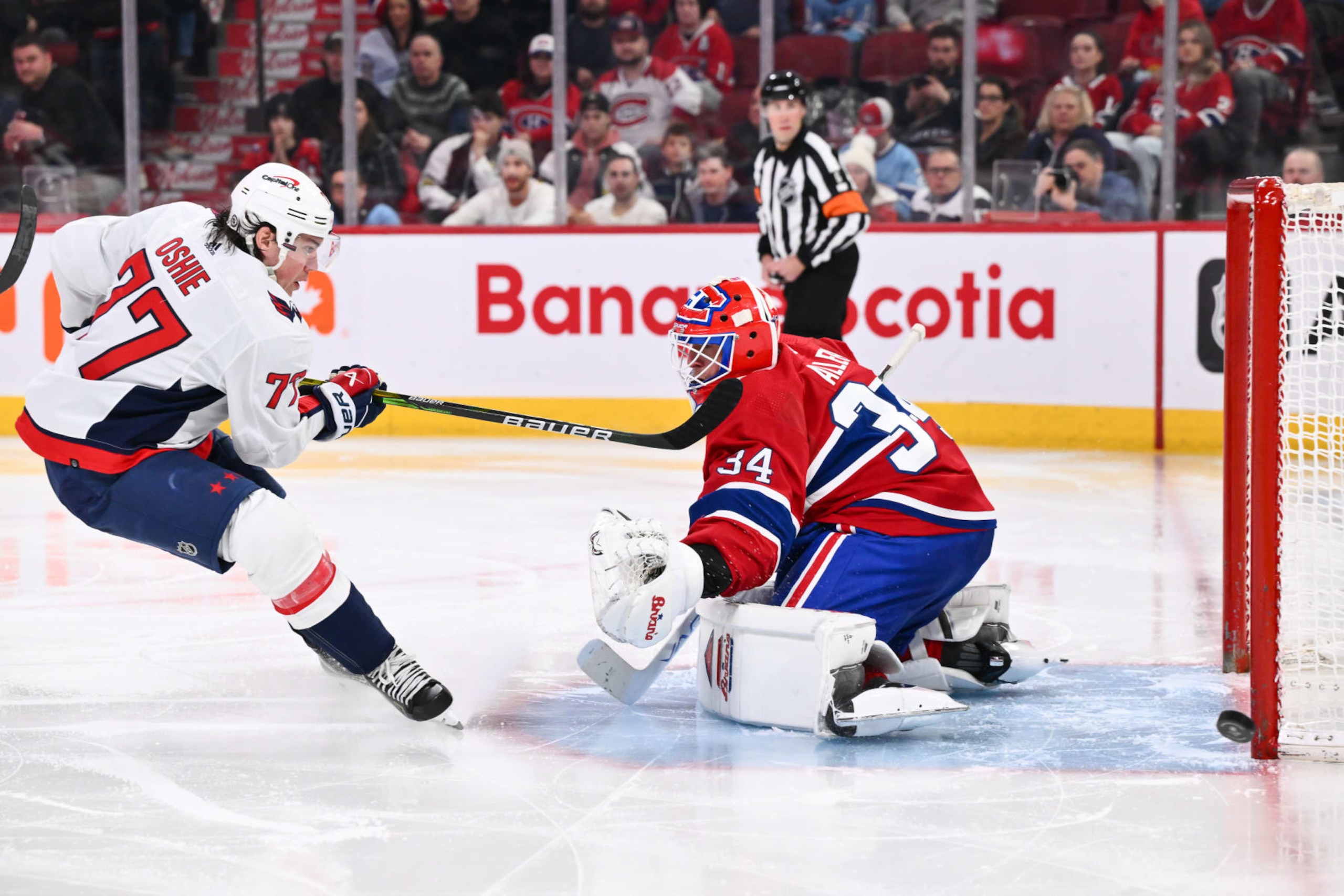 MONTREAL, CANADA - FEBRUARY 17:  T.J. Oshie #77 of the Washington Capitals shoots the puck wide of the net past goaltender Jake Allen #34 of the Montreal Canadiens during the third period at the Bell Centre on February 17, 2024 in Montreal, Quebec, Canada. The Washington Capitals defeated the Montreal Canadiens 4-3. (Photo by Minas Panagiotakis/Getty Images)
