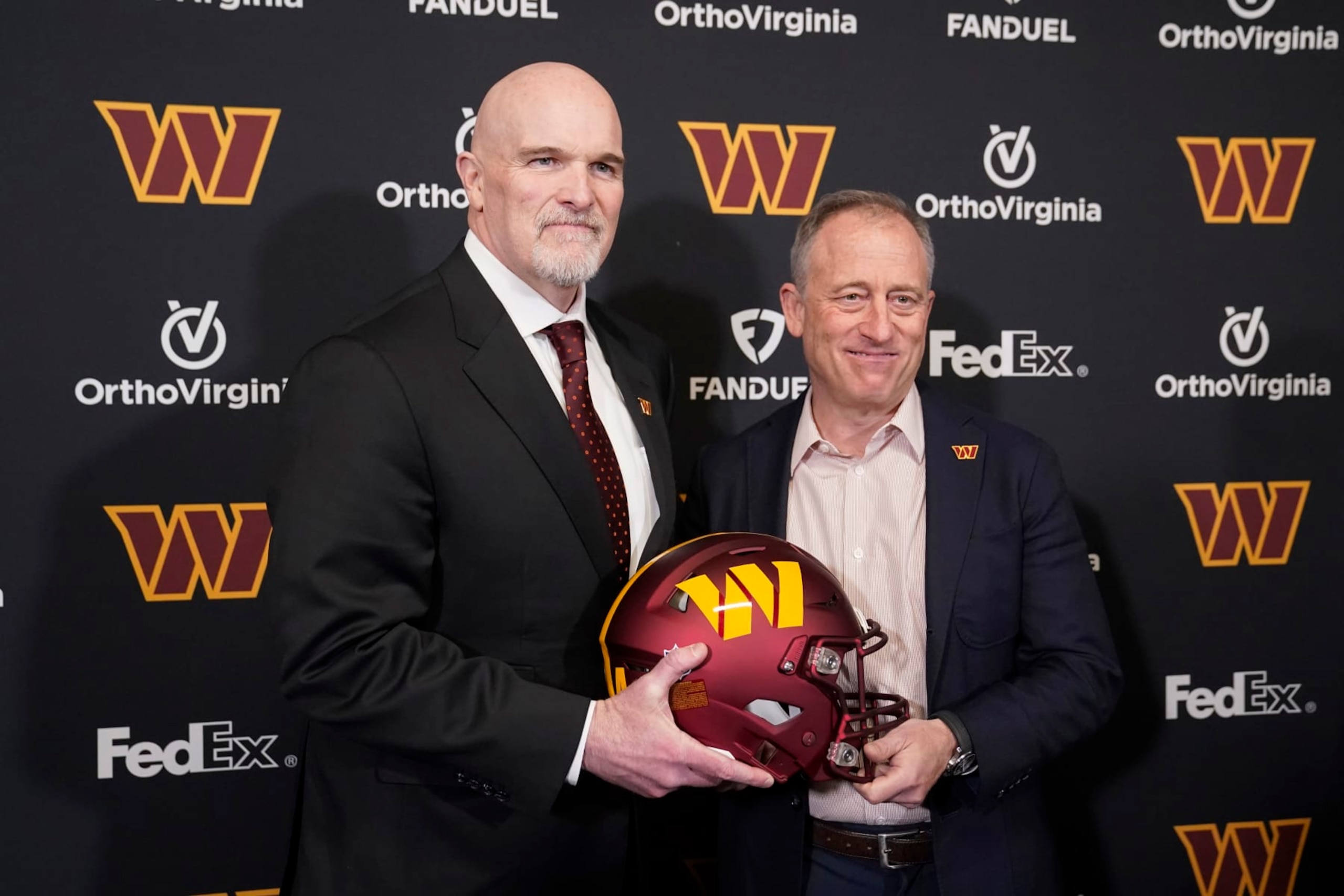 ASHBURN, VIRGINIA - FEBRUARY 05: Head coach Dan Quinn of the Washington Commanders poses for a photo with managing partner Josh Harris following a press conference at OrthoVirginia Training Center at Commanders Park on February 05, 2024 in Ashburn, Virginia. (Photo by Jess Rapfogel/Getty Images)
