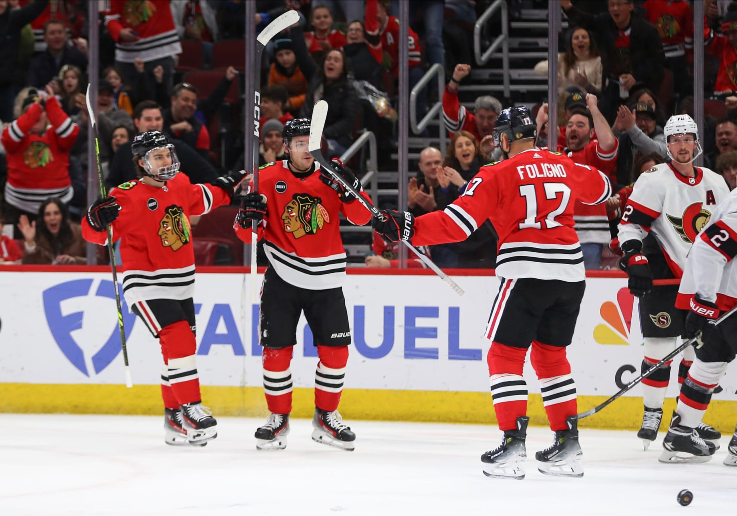 CHICAGO, IL - FEBRUARY 17: Connor Bedard #98 of the Chicago Blackhawks Philipp Kurashev #23 of the Chicago Blackhawks celebrate with Nick Foligno #17 of the Chicago Blackhawks after scoring a goal  during the first period against the Ottawa Senators at the United Center on February 15, 2024 in Chicago, Illinois. (Photo by Melissa Tamez/Icon Sportswire via Getty Images)