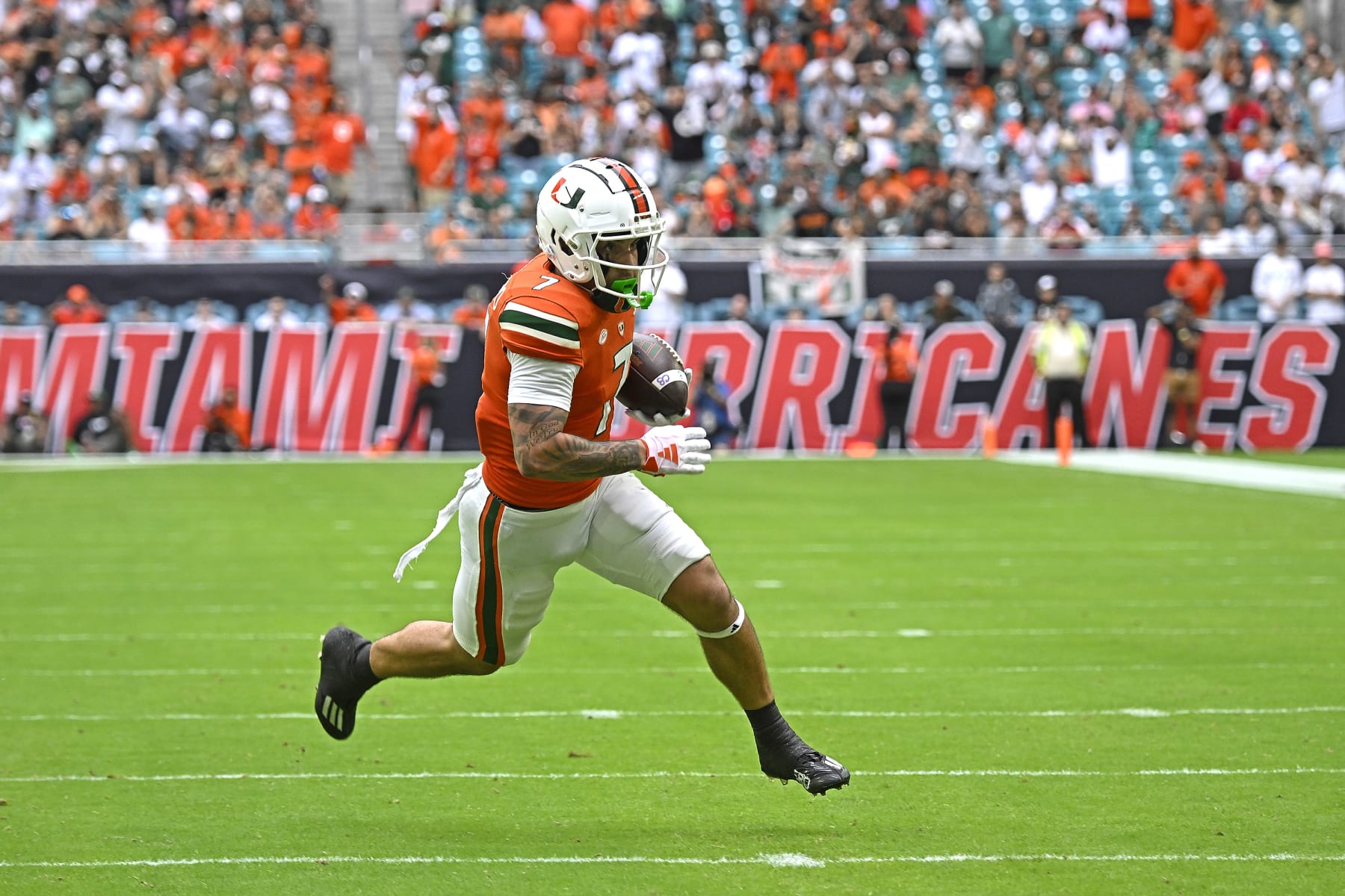 MIAMI GARDENS, FL - NOVEMBER 18:  Miami wide receiver Xavier Restrepo (7) takes a reception 15 yards for a touchdown in the first quarter as the Miami Hurricanes faced the Louisville Cardinals on November 18, 2023, at Hard Rock Stadium in Miami Gardens, Florida. (Photo by Samuel Lewis/Icon Sportswire via Getty Images)