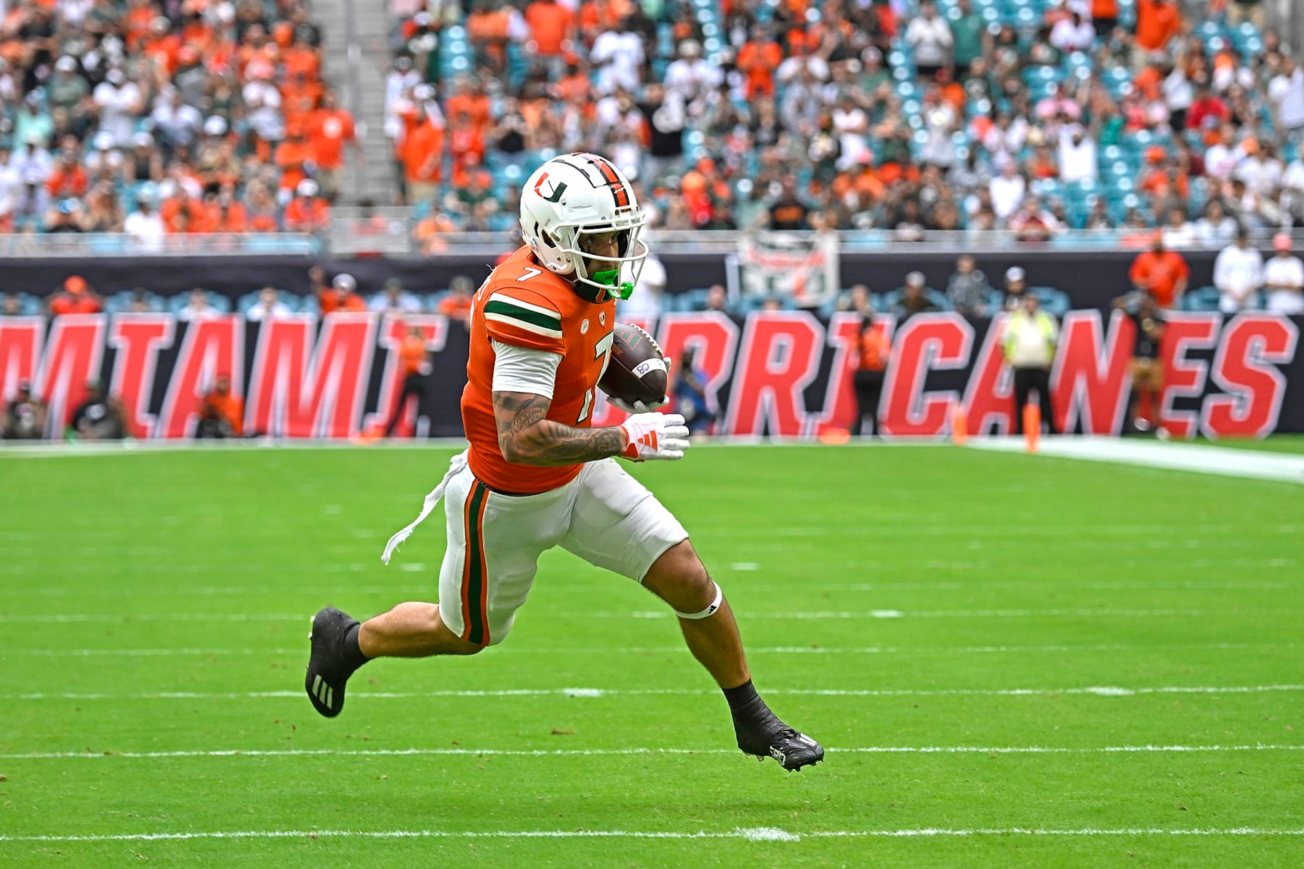 MIAMI GARDENS, FL - NOVEMBER 18:  Miami wide receiver Xavier Restrepo (7) takes a reception 15 yards for a touchdown in the first quarter as the Miami Hurricanes faced the Louisville Cardinals on November 18, 2023, at Hard Rock Stadium in Miami Gardens, Florida. (Photo by Samuel Lewis/Icon Sportswire via Getty Images)
