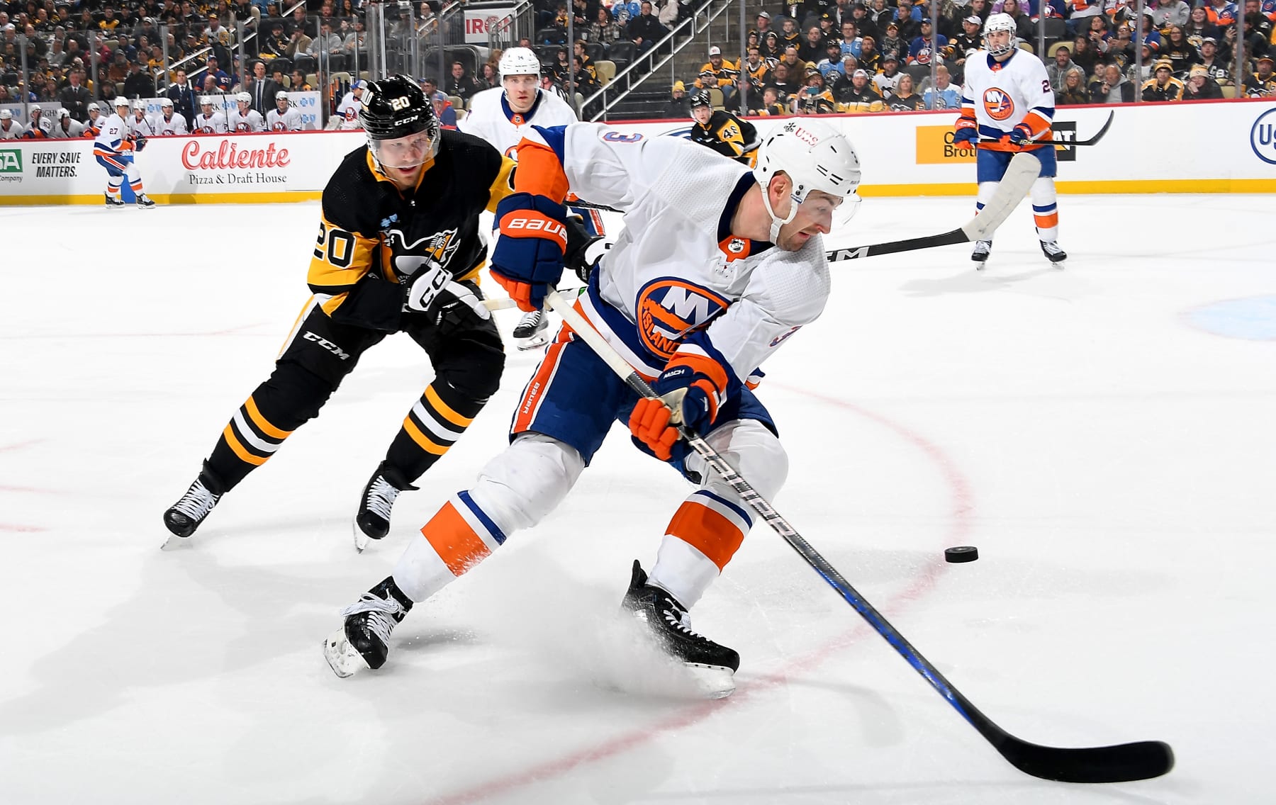 PITTSBURGH, PA - FEBRUARY 20:  Adam Pelech #3 of the New York Islanders battles against Lars Eller #20 of the Pittsburgh Penguins at PPG PAINTS Arena on February 20, 2024 in Pittsburgh, Pennsylvania. (Photo by Joe Sargent/NHLI via Getty Images)