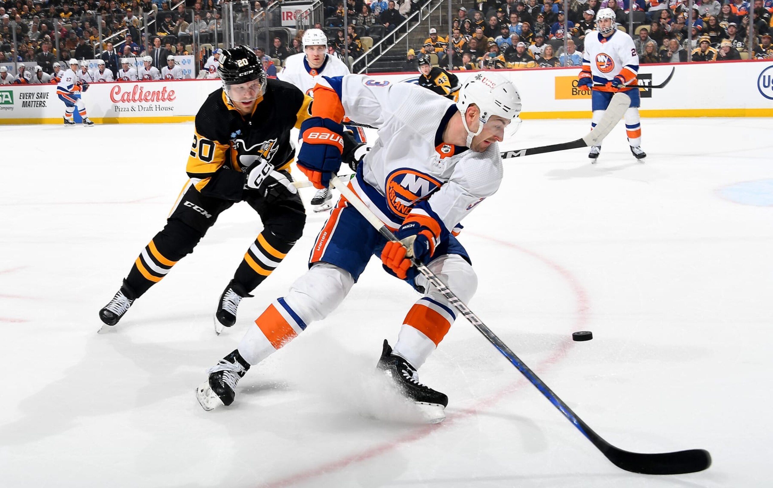 PITTSBURGH, PA - FEBRUARY 20:  Adam Pelech #3 of the New York Islanders battles against Lars Eller #20 of the Pittsburgh Penguins at PPG PAINTS Arena on February 20, 2024 in Pittsburgh, Pennsylvania. (Photo by Joe Sargent/NHLI via Getty Images)