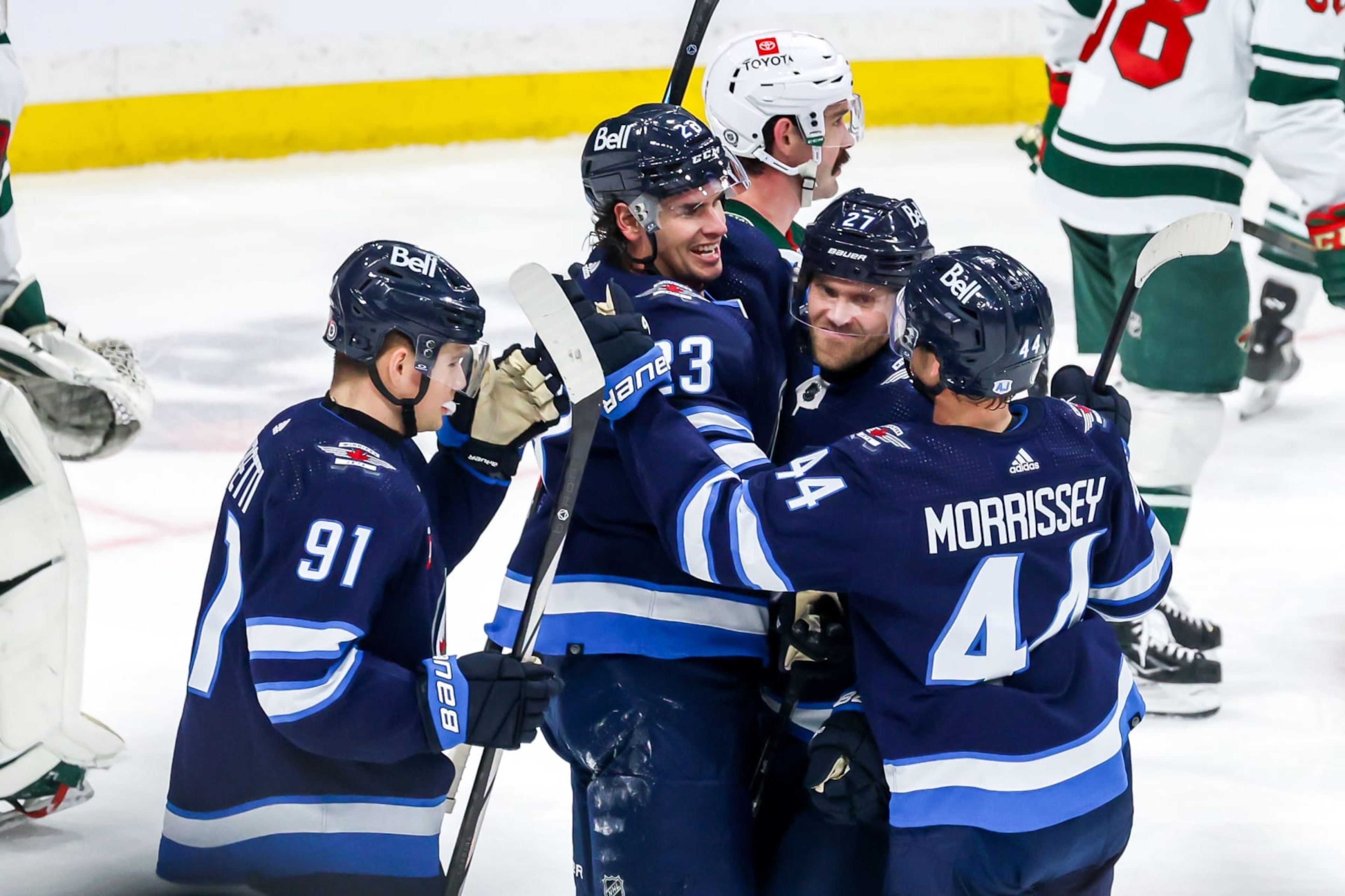 WINNIPEG, CANADA - FEBRUARY 20: Cole Perfetti #91, Sean Monahan #23, Nikolaj Ehlers #27 and Josh Morrissey #44 of the Winnipeg Jets celebrate a third period goal against the Minnesota Wild at the Canada Life Centre on February 20, 2024 in Winnipeg, Manitoba, Canada. (Photo by Jonathan Kozub/NHLI via Getty Images) WINNIPEG, CANADA - FEBRUARY 20: Cole Perfetti #91, Sean Monahan #23, Nikolaj Ehlers #27 and Josh Morrissey #44 of the Winnipeg Jets celebrate a third period goal against the Minnesota Wild at the Canada Life Centre on February 20, 2024 in Winnipeg, Manitoba, Canada. (Photo by Jonathan Kozub/NHLI via Getty Images)